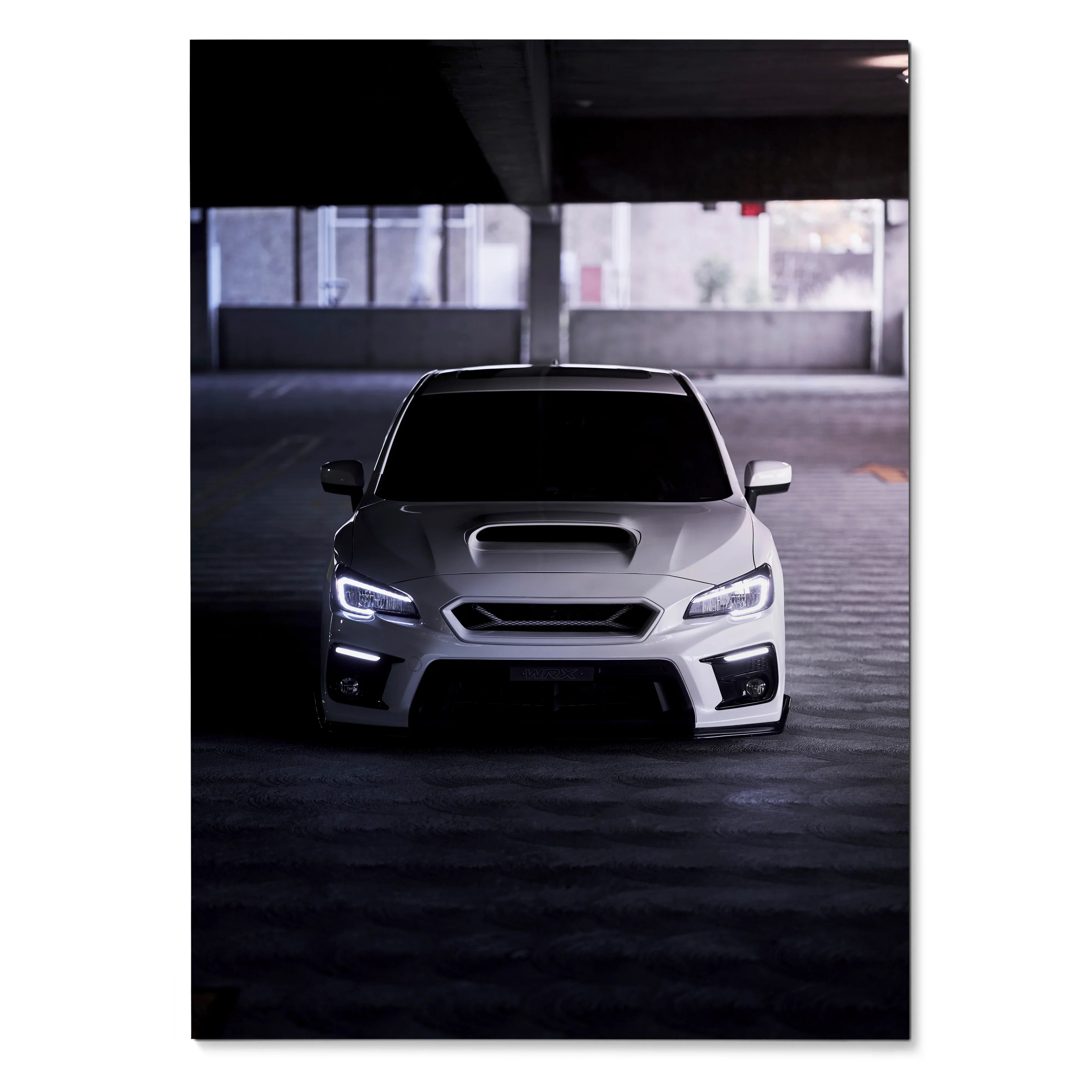 Subaru WRX front view with illuminated headlights poster wall art in dim parking garage.