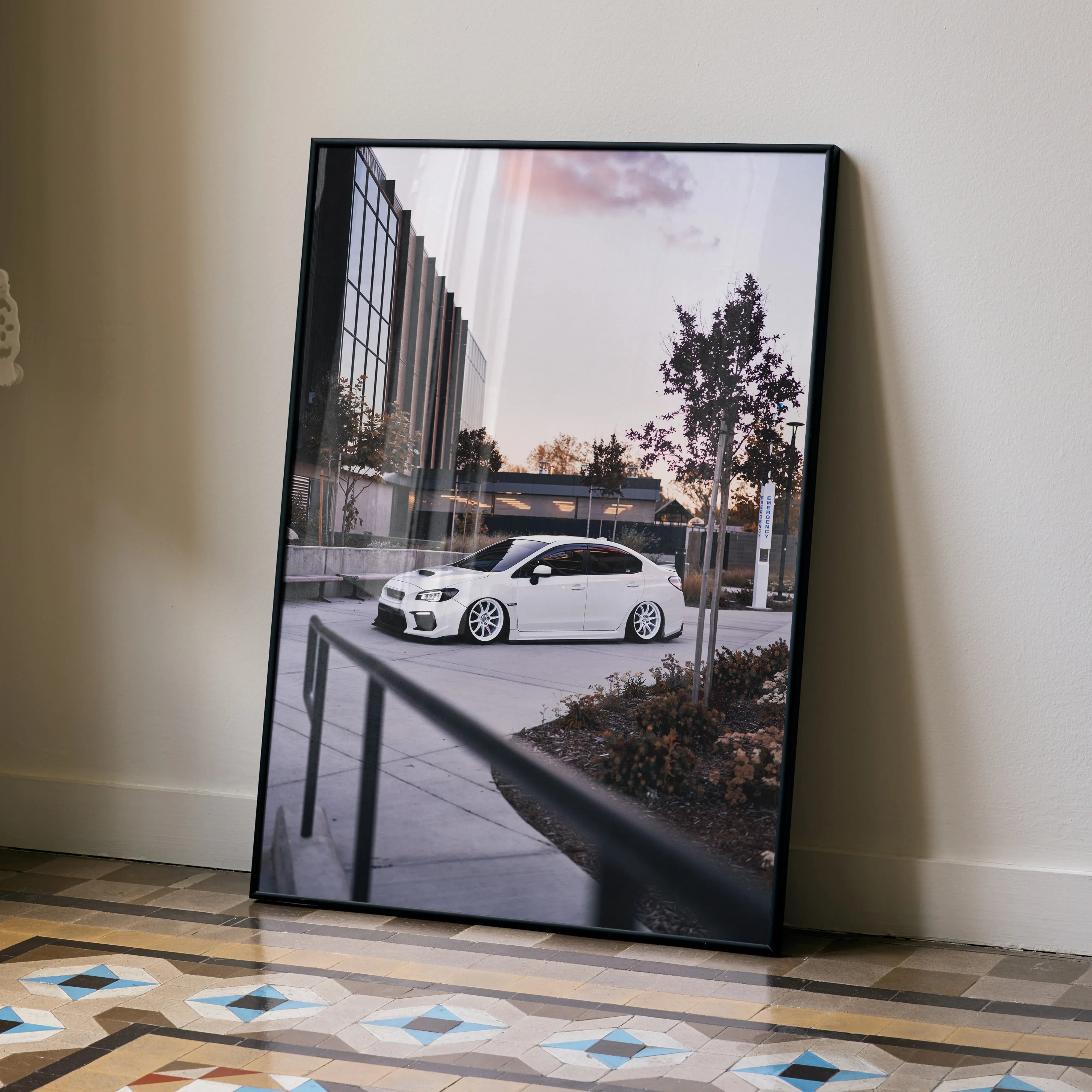 Subaru WRX white car poster wall art with urban cityscape and sunset sky background.