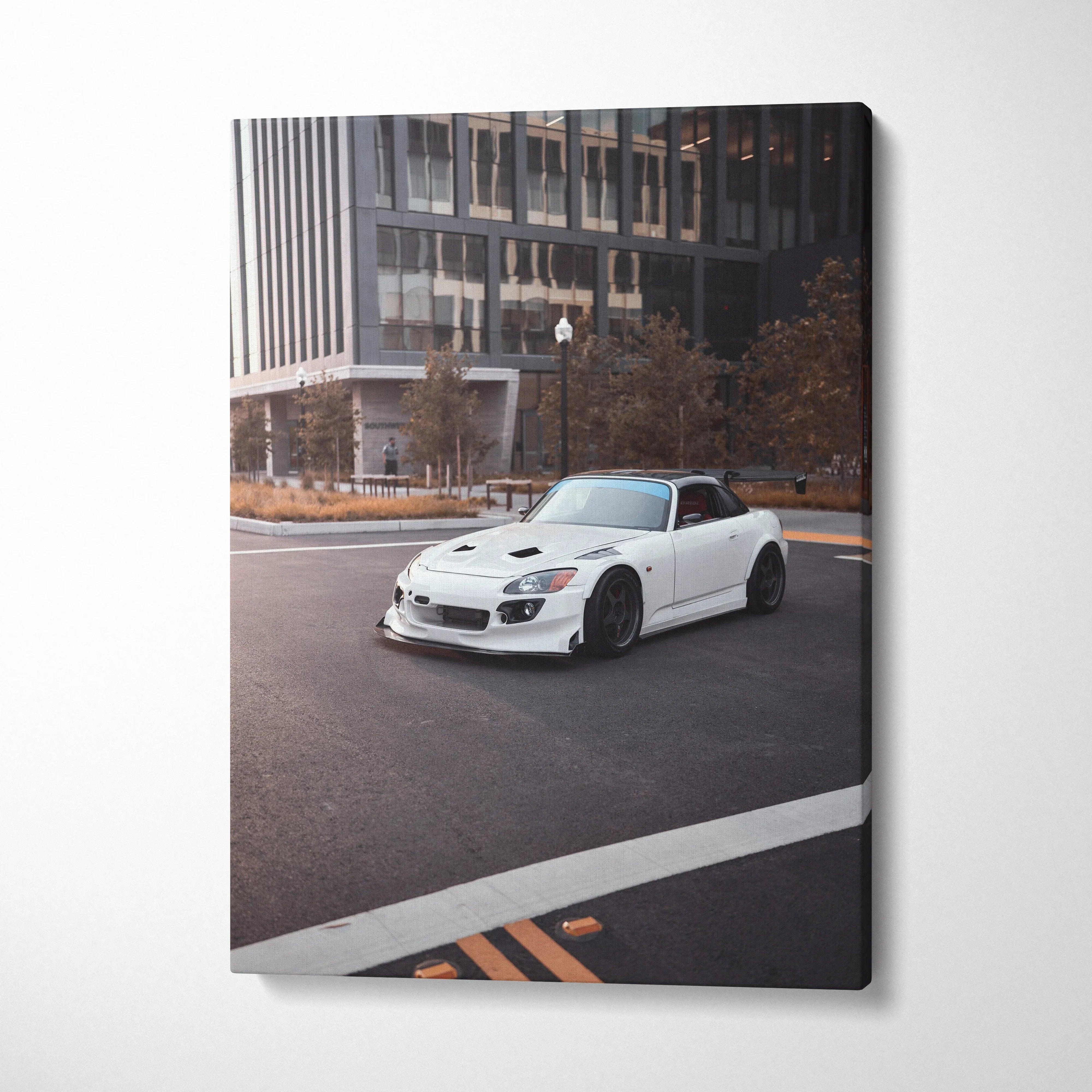White Honda S2000 sports car on city street canvas wall art with modern urban backdrop.