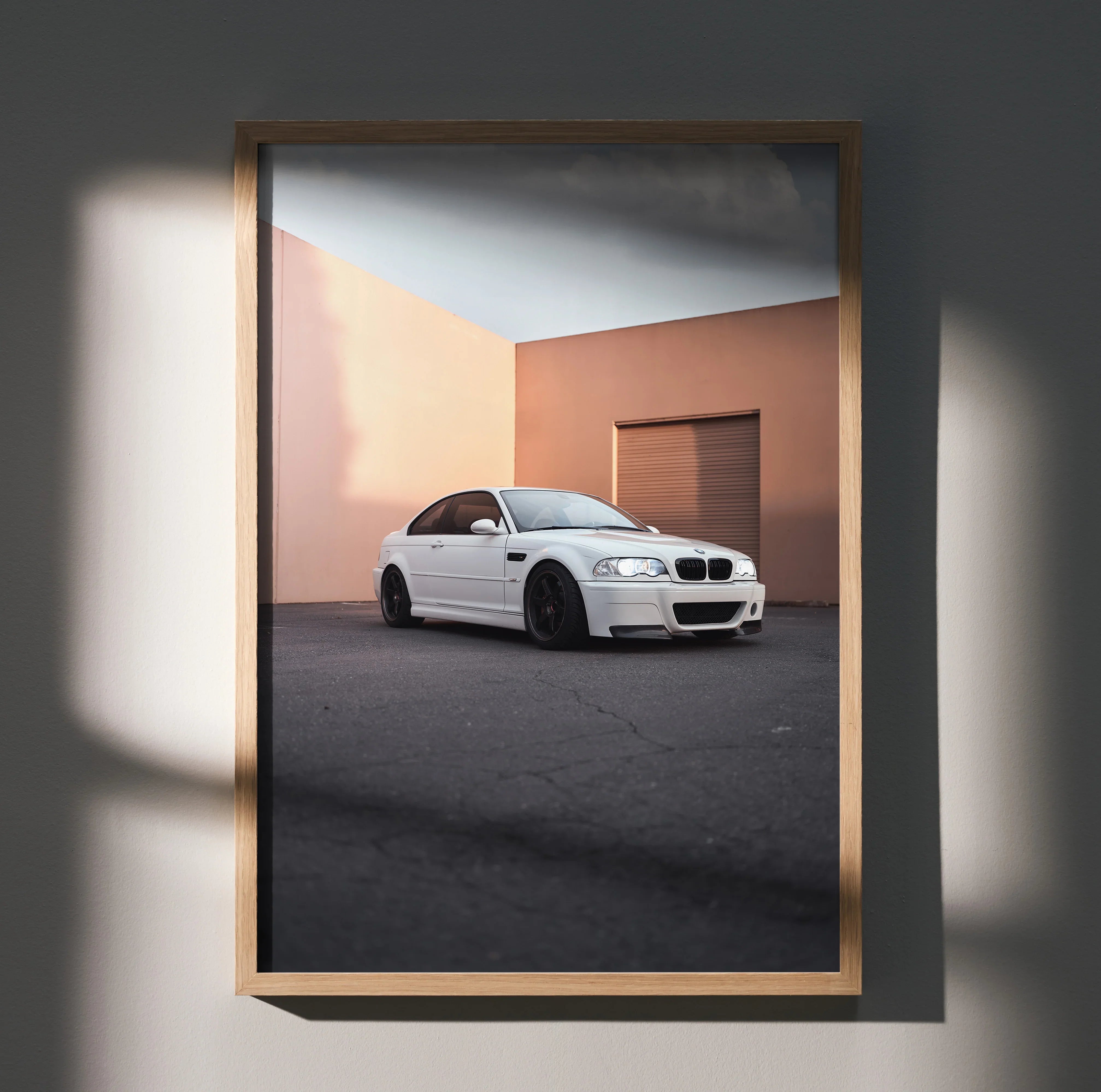 BMW E46 M3 in white parked against peach wall, modern automotive poster wall art.