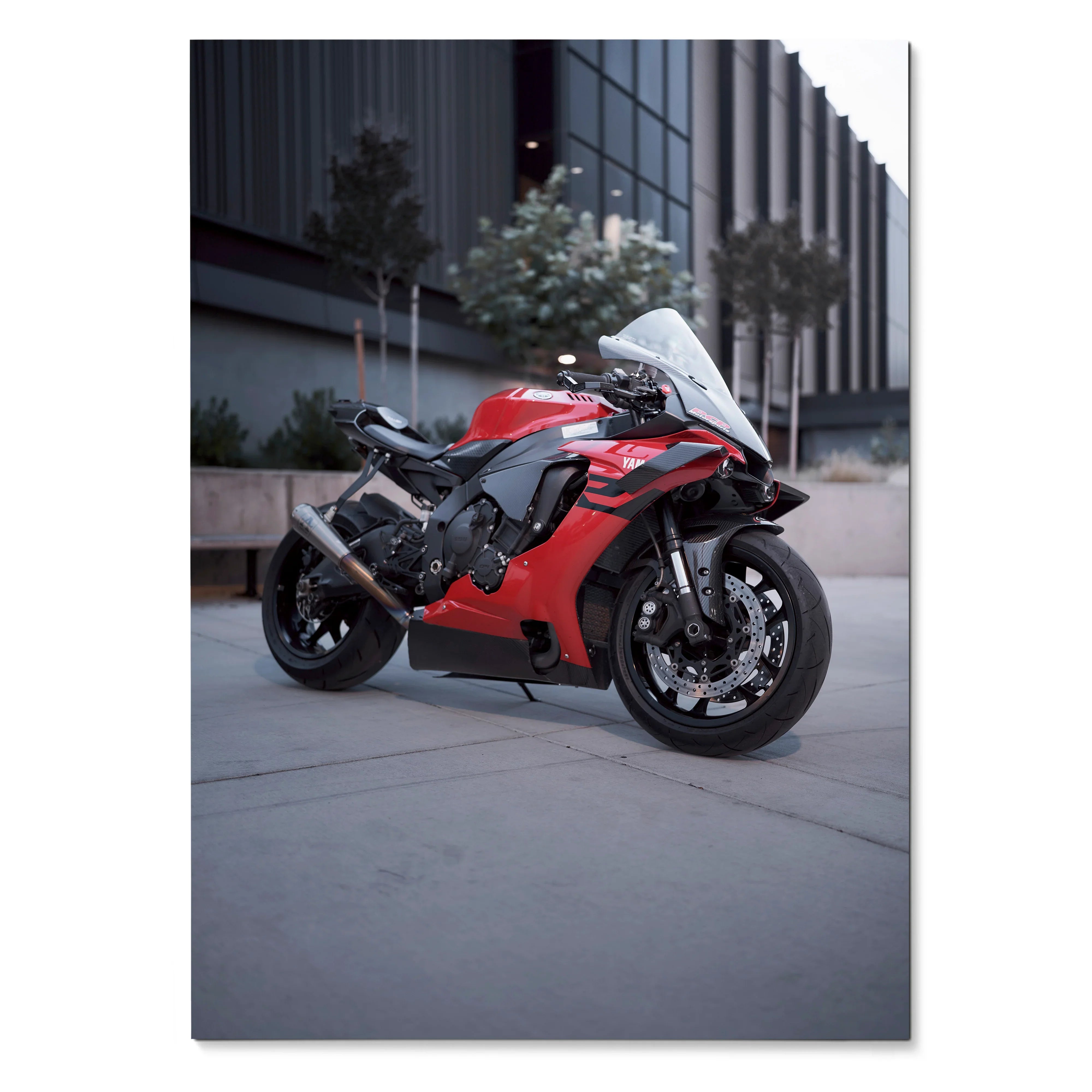 Red Yamaha R1 sport motorcycle leaning on side stand on urban street poster wall art.