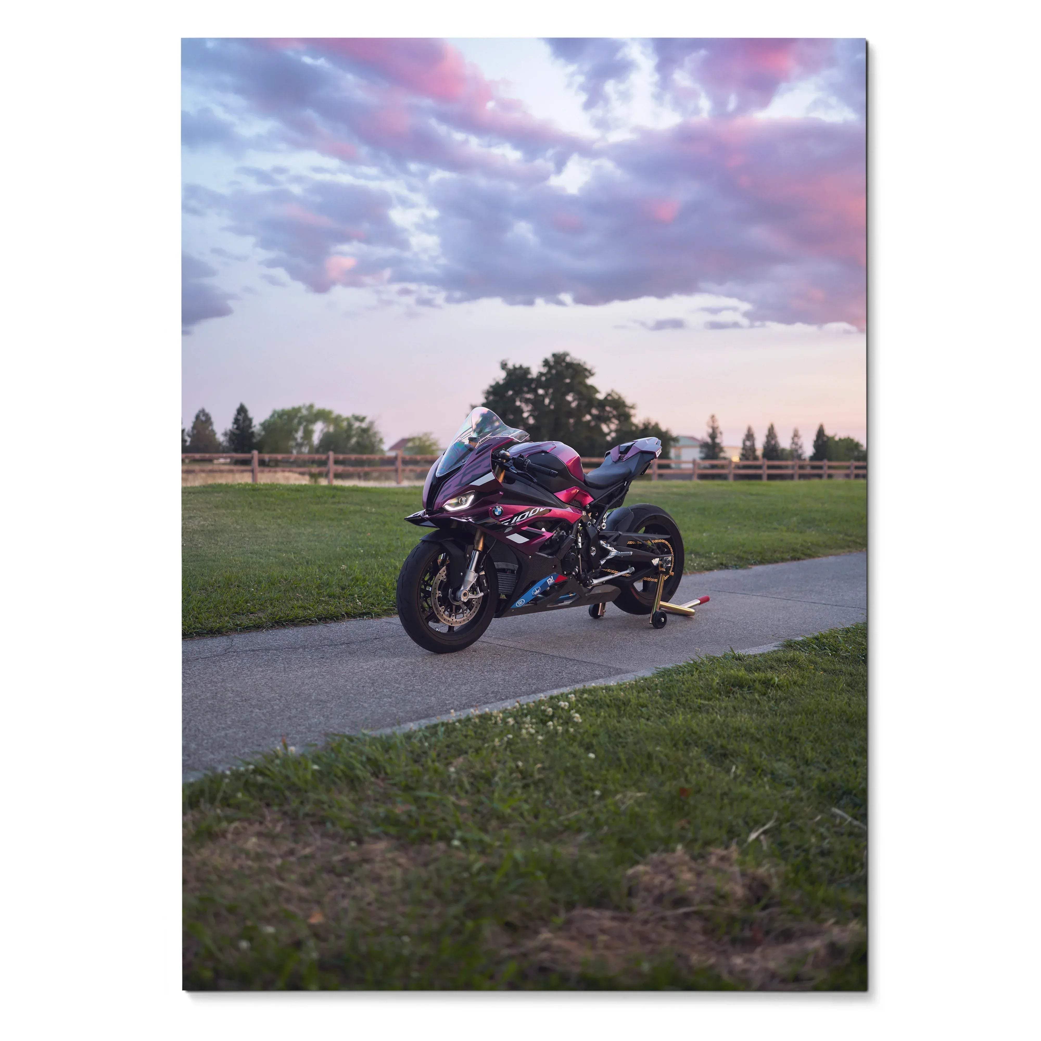 BMW S1000RR motorcycle parked on pathway during sunset Poster Wall Art with colorful sky background.