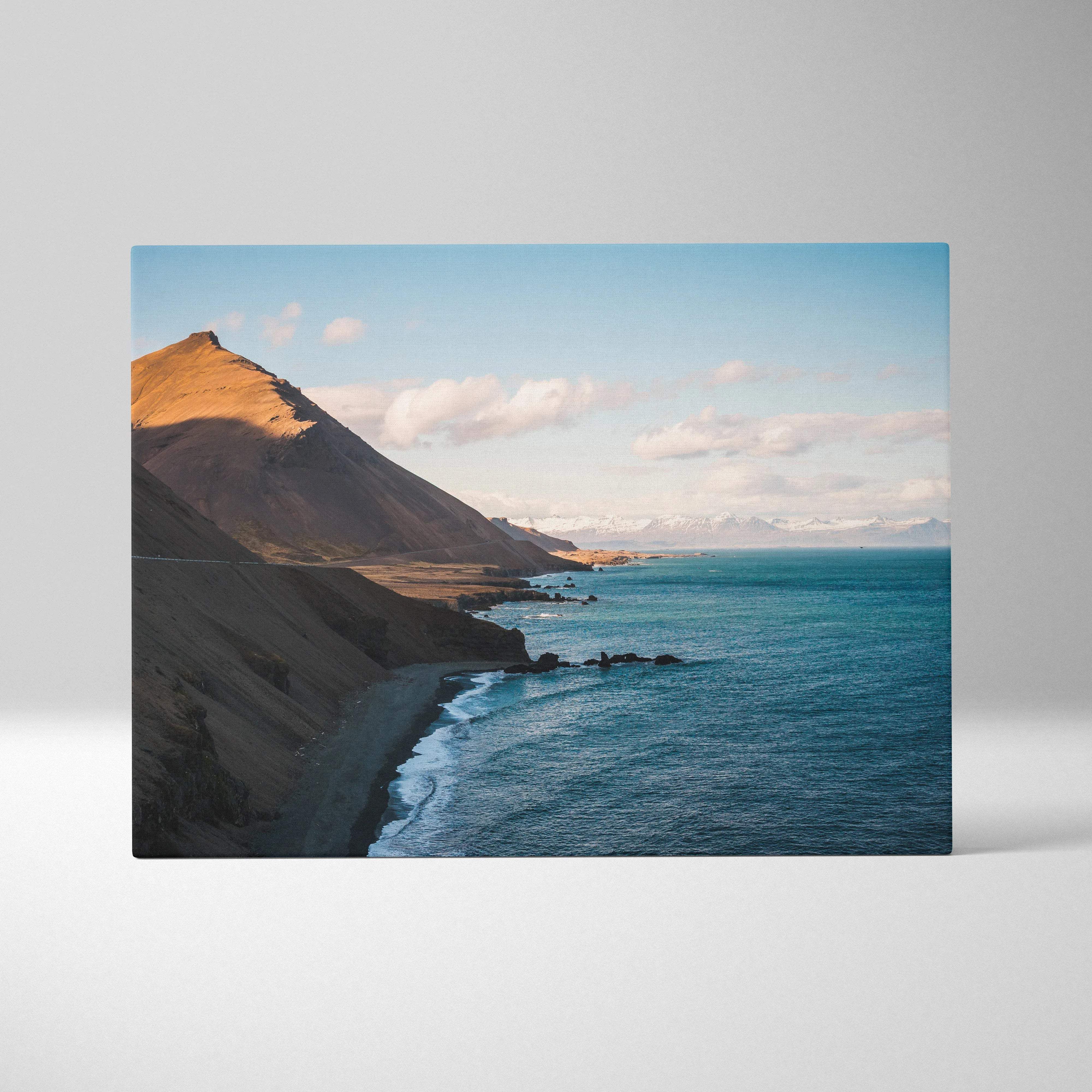 Canvas wall art of Iceland coastline with golden sunlit cliffs and calm blues