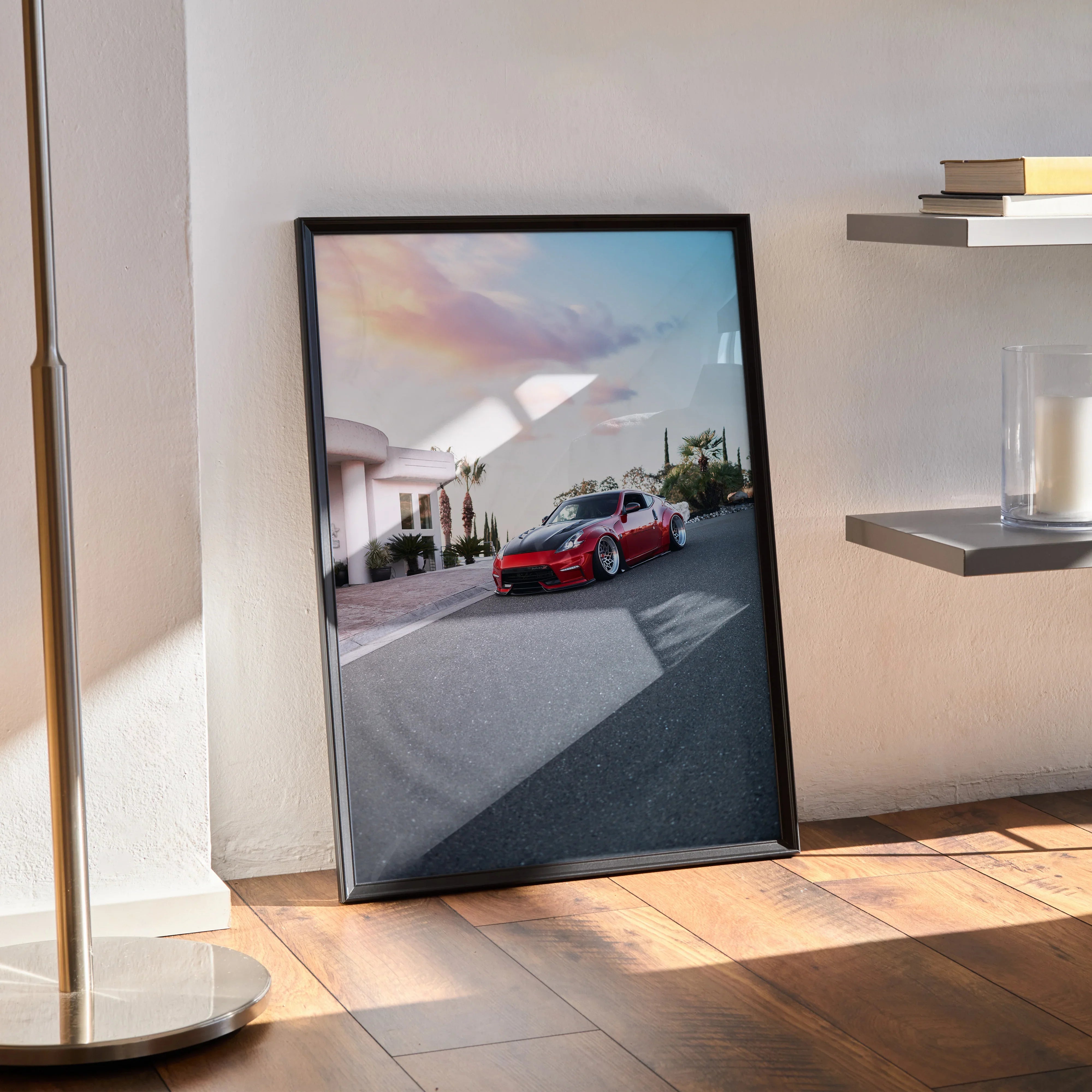 Nissan 370z poster wall art with red sports car on sunset street scene in black frame.