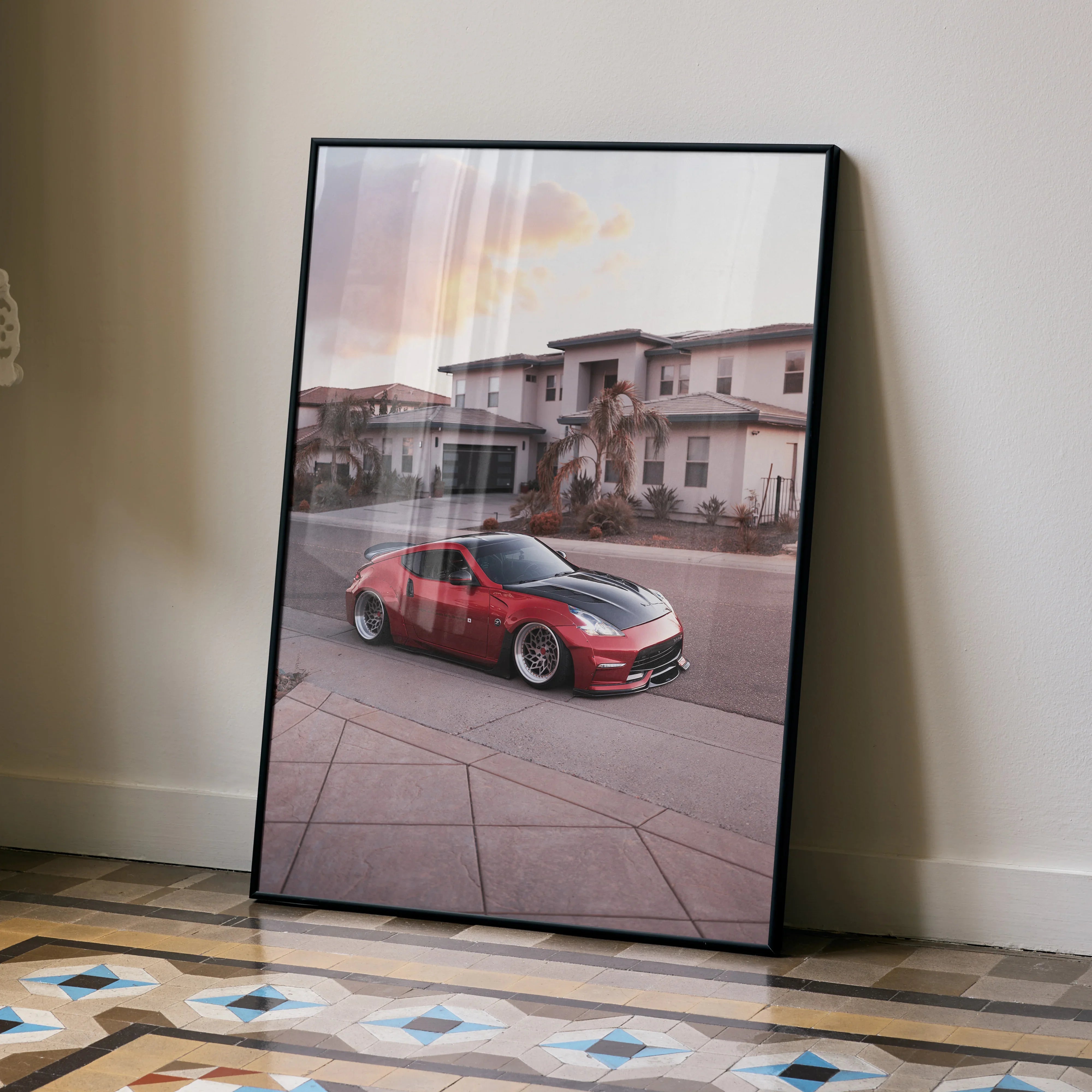 Nissan 370z red sports car poster leaning on wall, modern home exterior wall art.