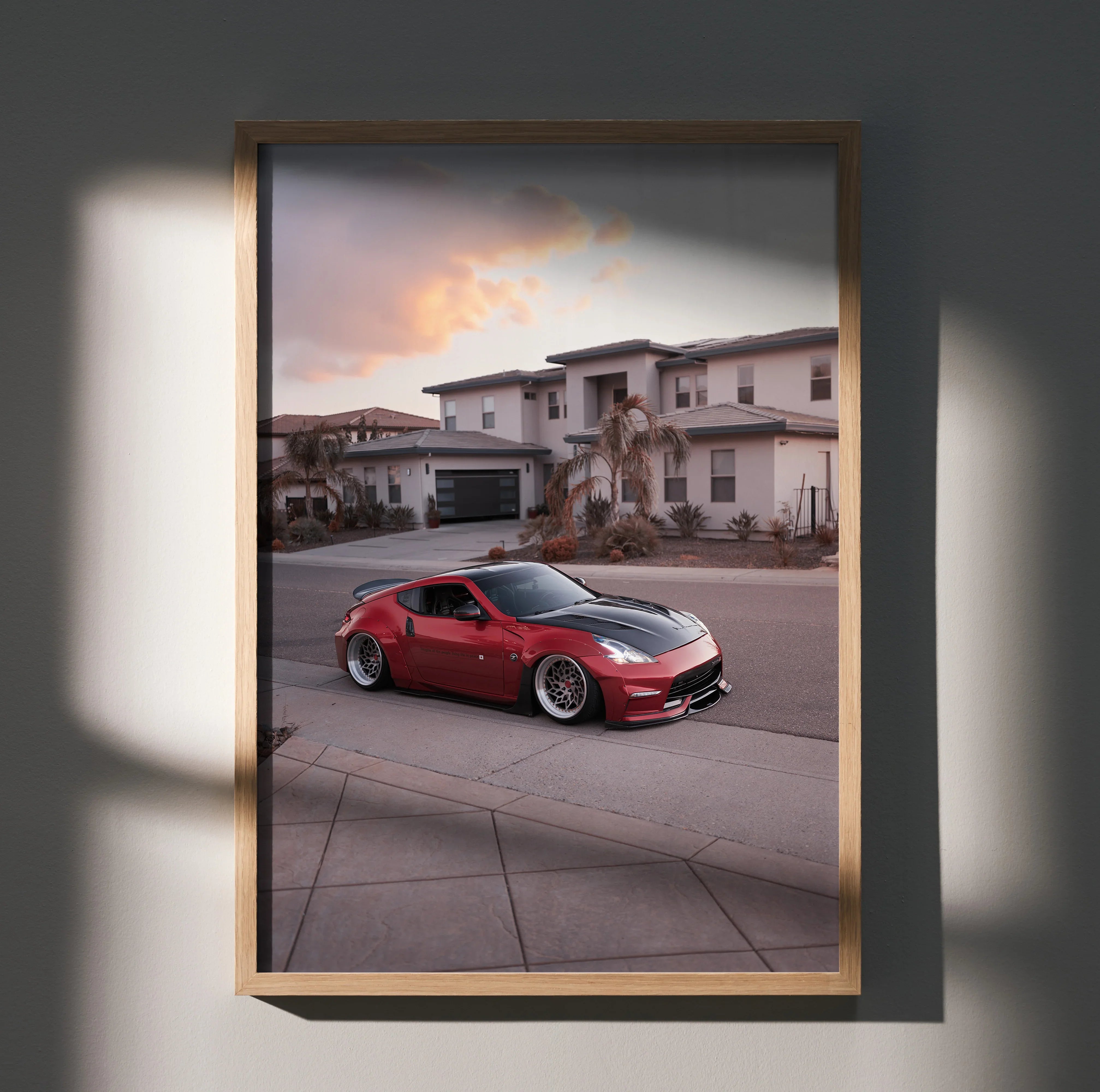 Red Nissan 370z sports car poster with modern houses background, automotive wall art.