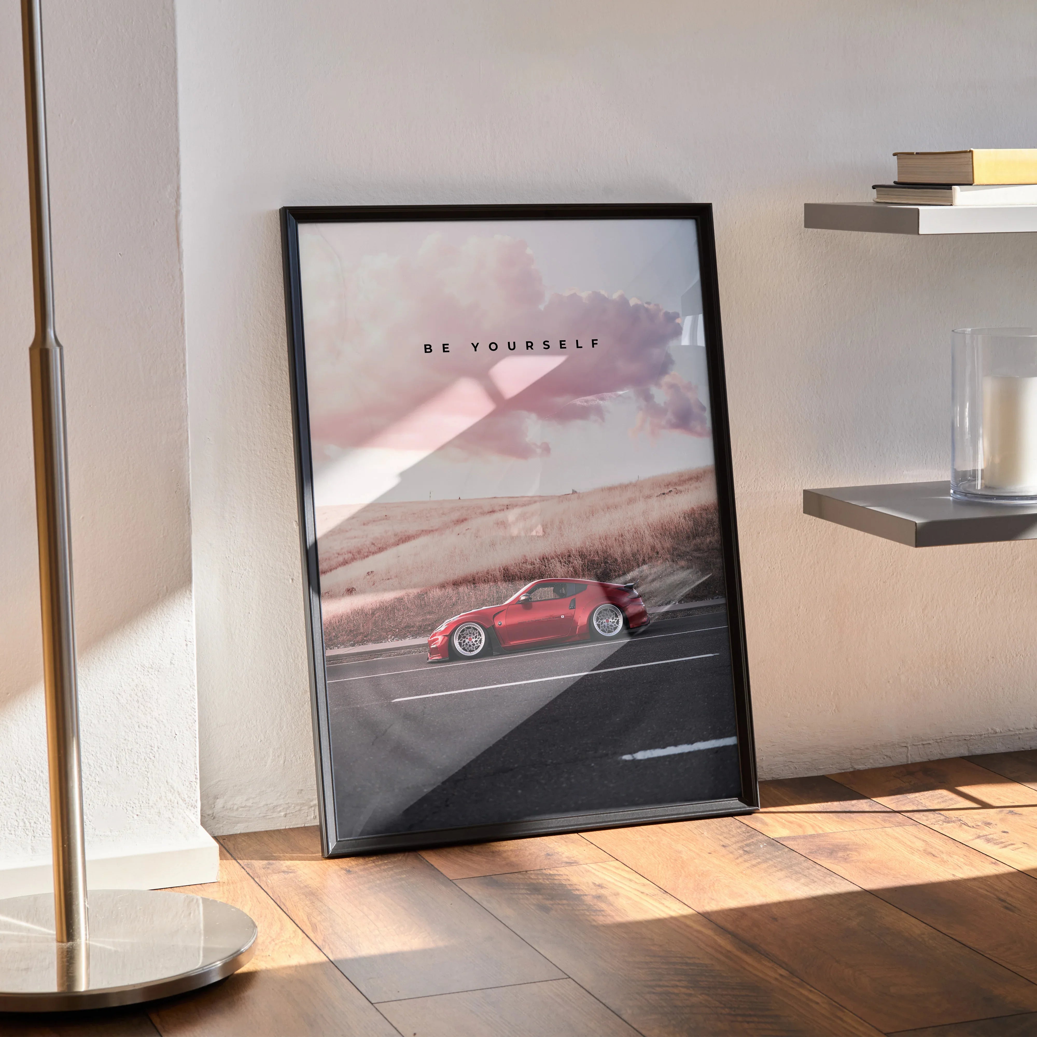 Motivational poster wall art featuring red Nissan 370z sports car on road with inspiring text in black frame.