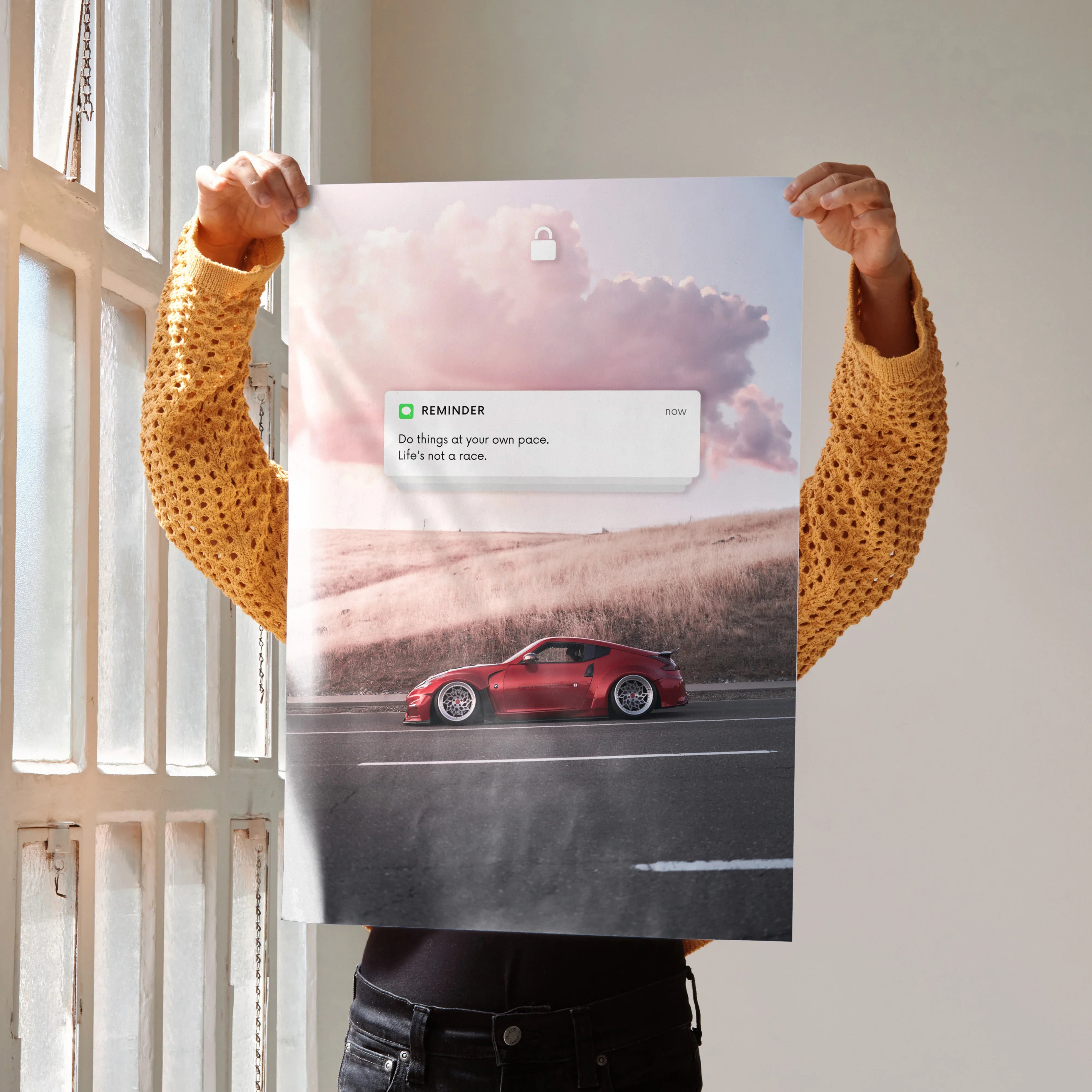 Motivational poster wall art featuring a red Nissan 370z driving on a road under pink clouds.