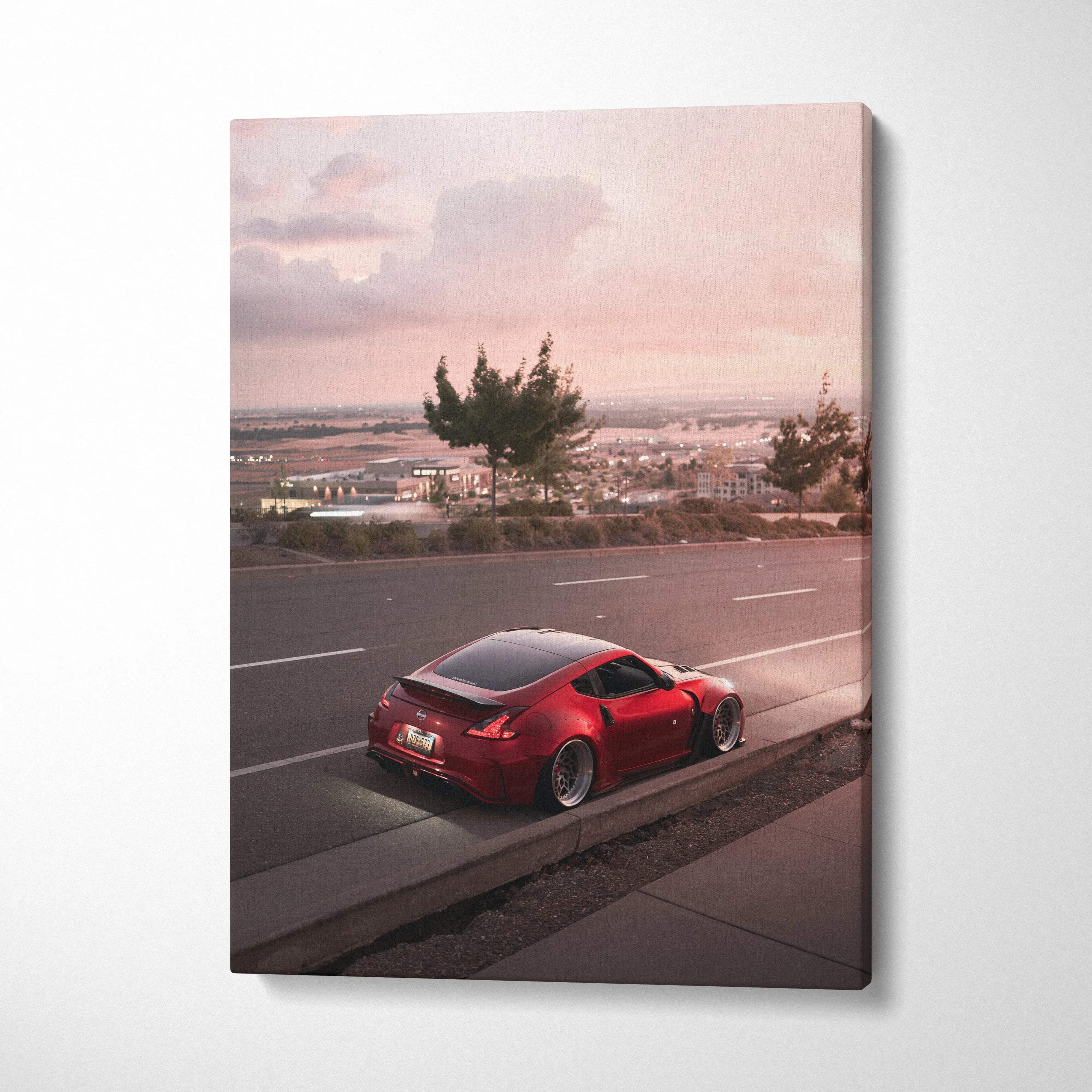 Red Nissan 370z parked by roadside at sunset on vertical canvas wall art.