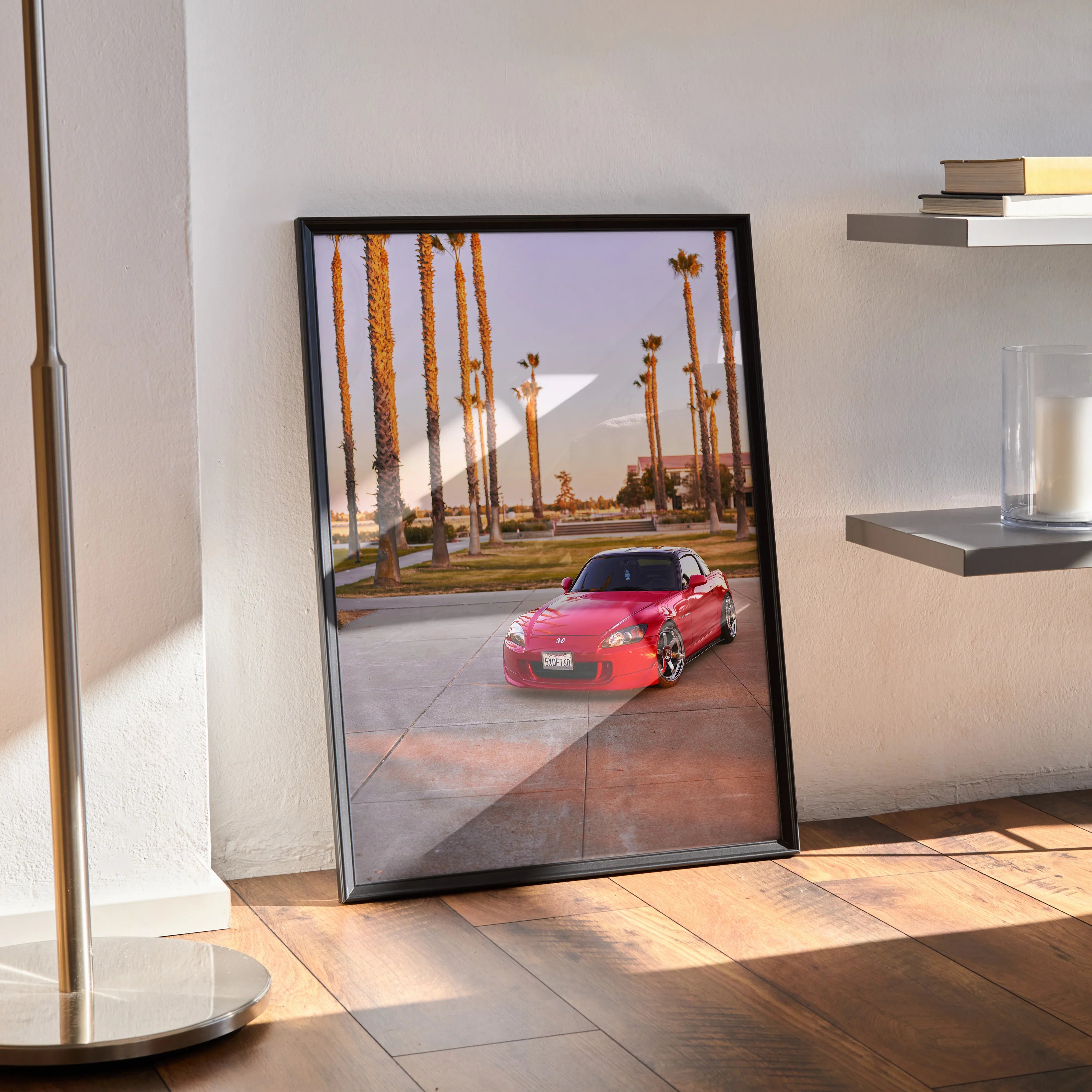Honda S2000 red sports car poster with palm trees, framed wall art on wooden floor.
