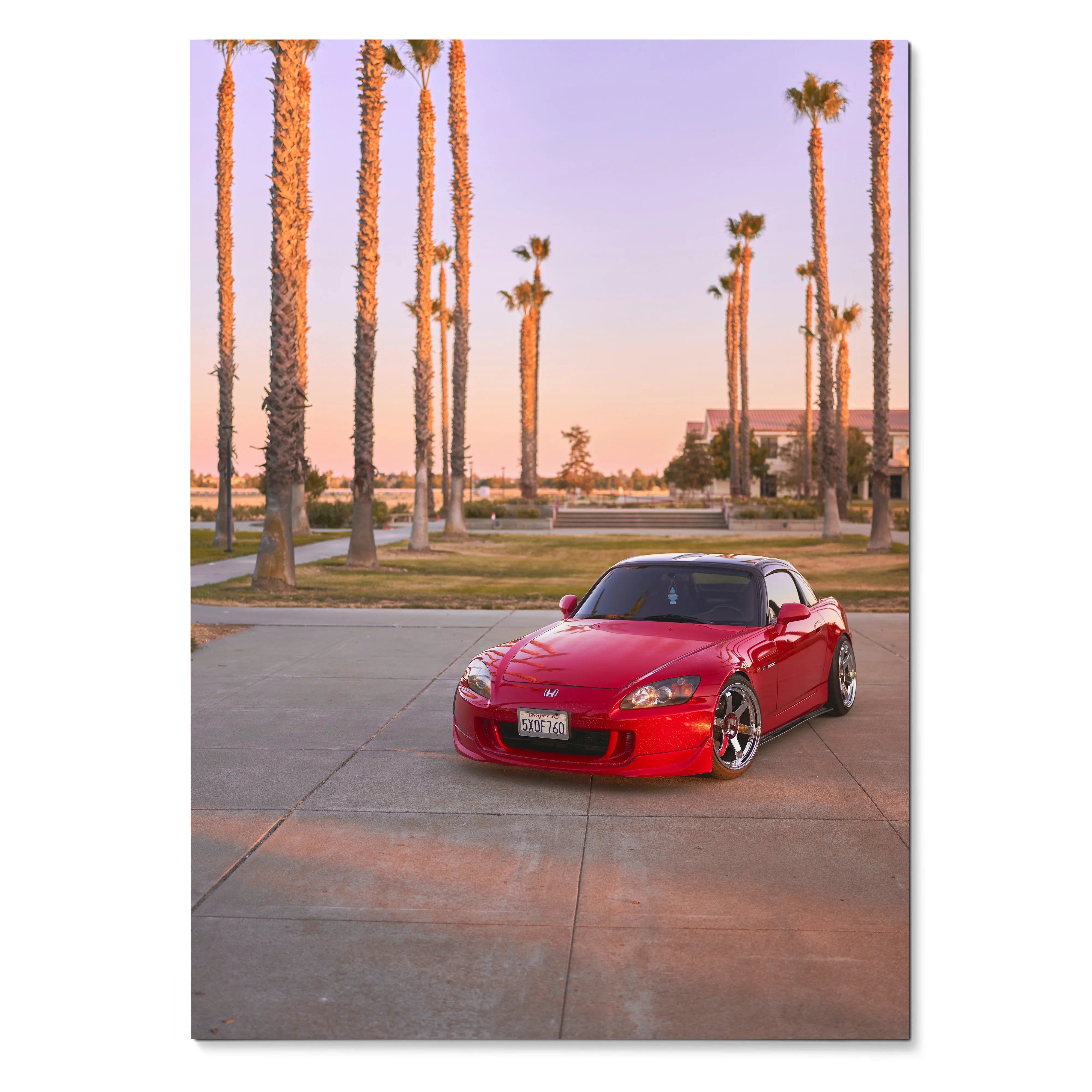Red Honda S2000 parked on concrete under tall palm trees at sunset poster wall art.
