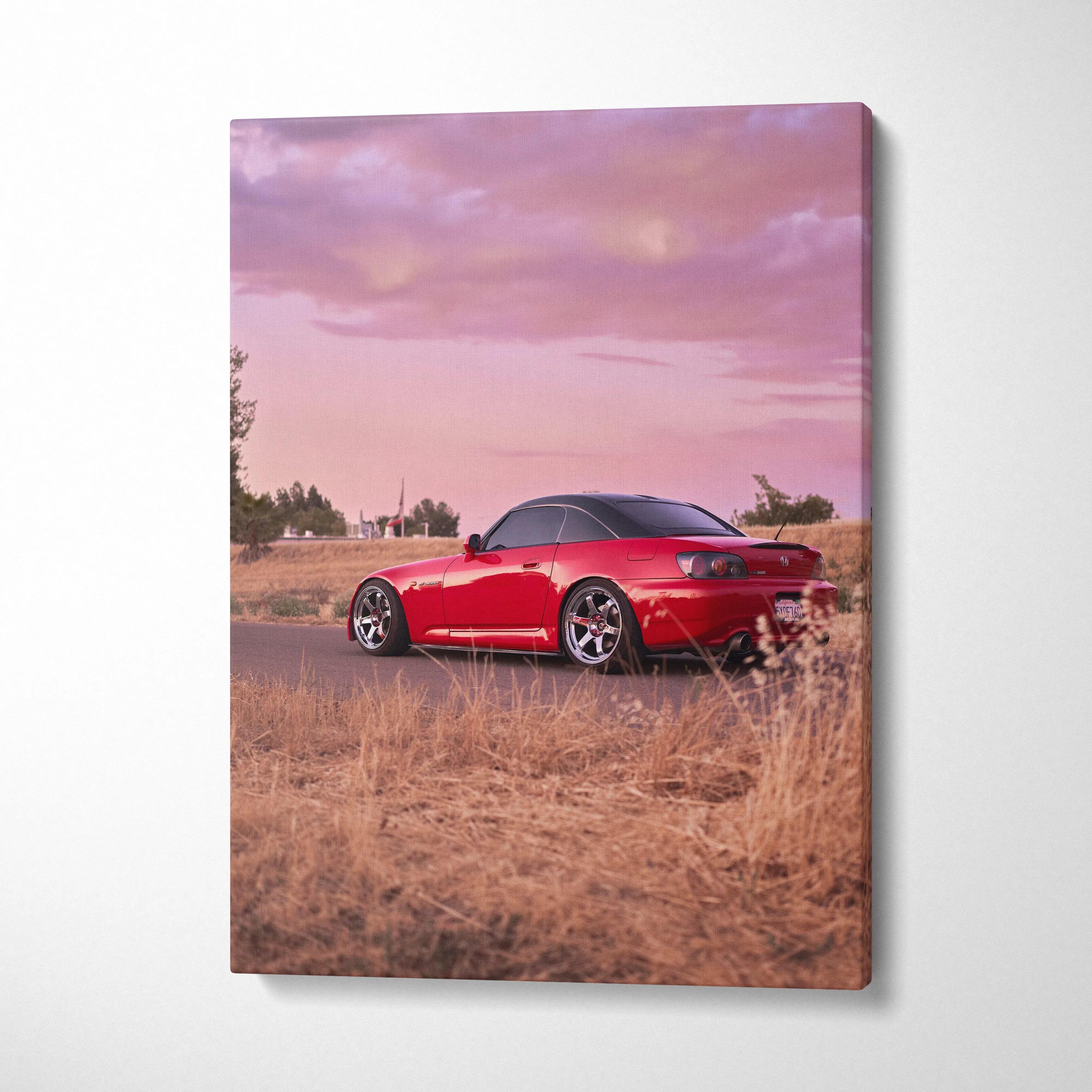 Red Honda S2000 sports car parked in dry grass under pink sunset sky vertical canvas wall art.
