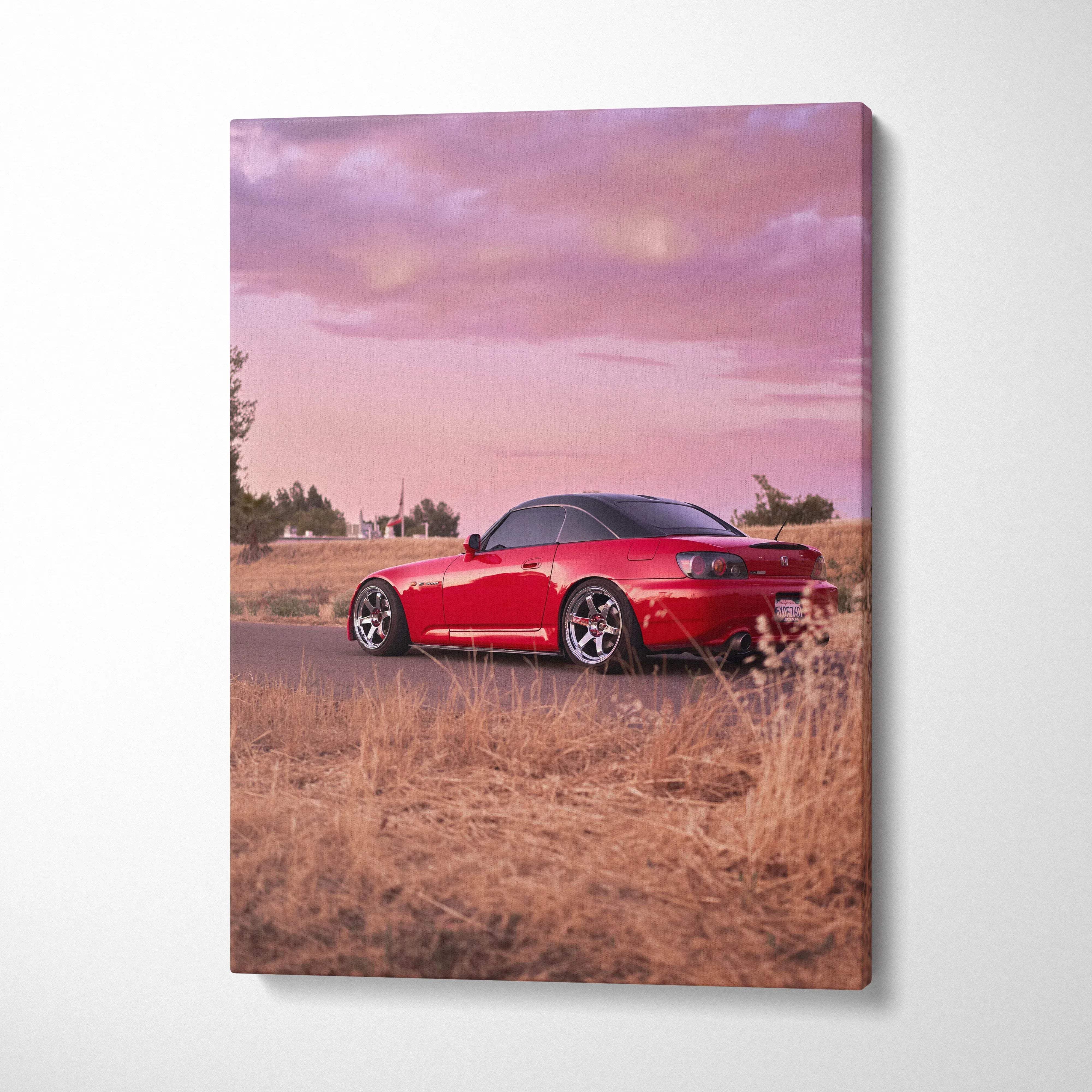 Canvas wall art featuring a red honda s2000 sports car with black roof and silver rims in sunset pink tones