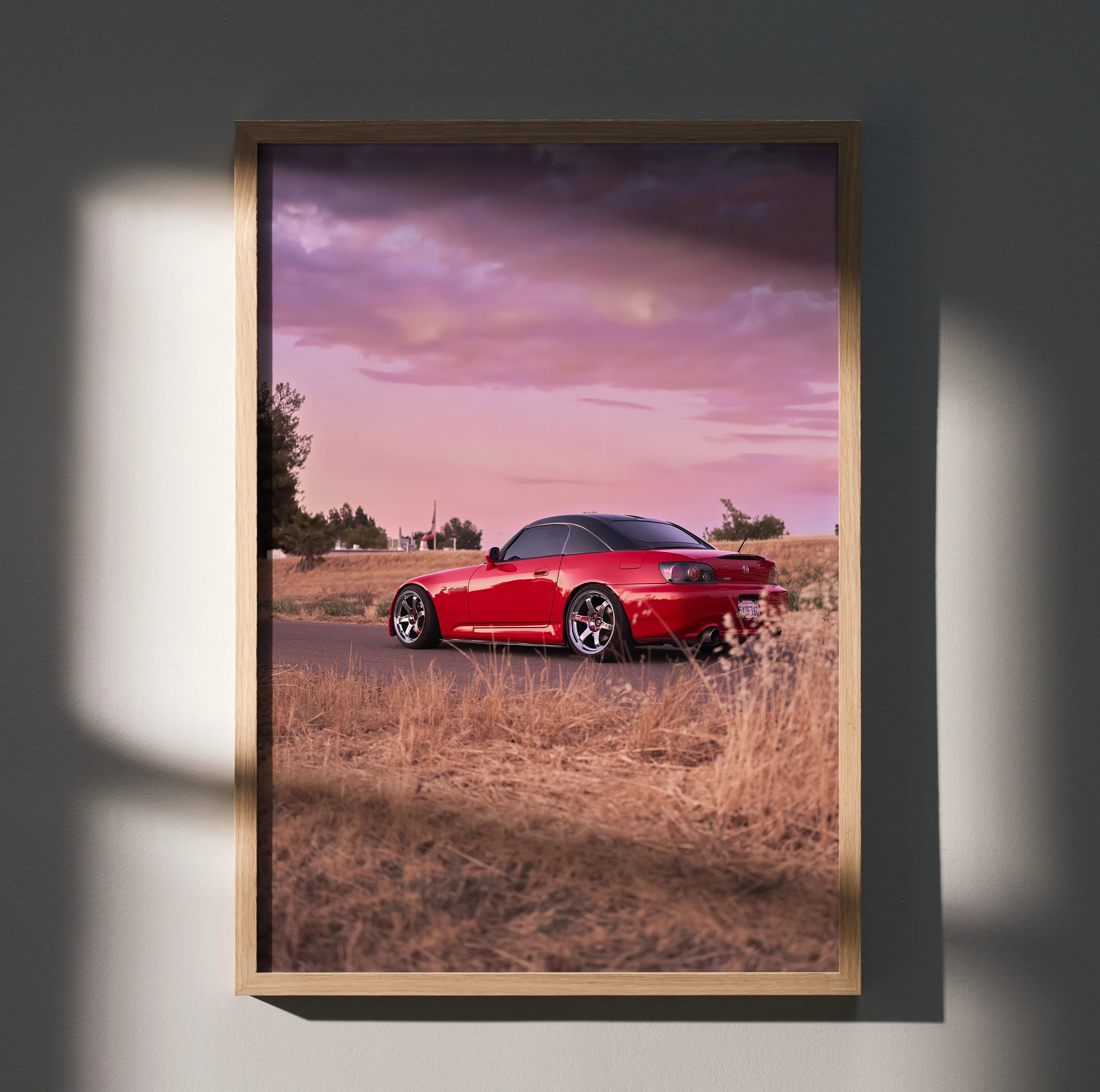 Honda S2000 red sports car at sunset in desert setting poster wall art in wooden frame.