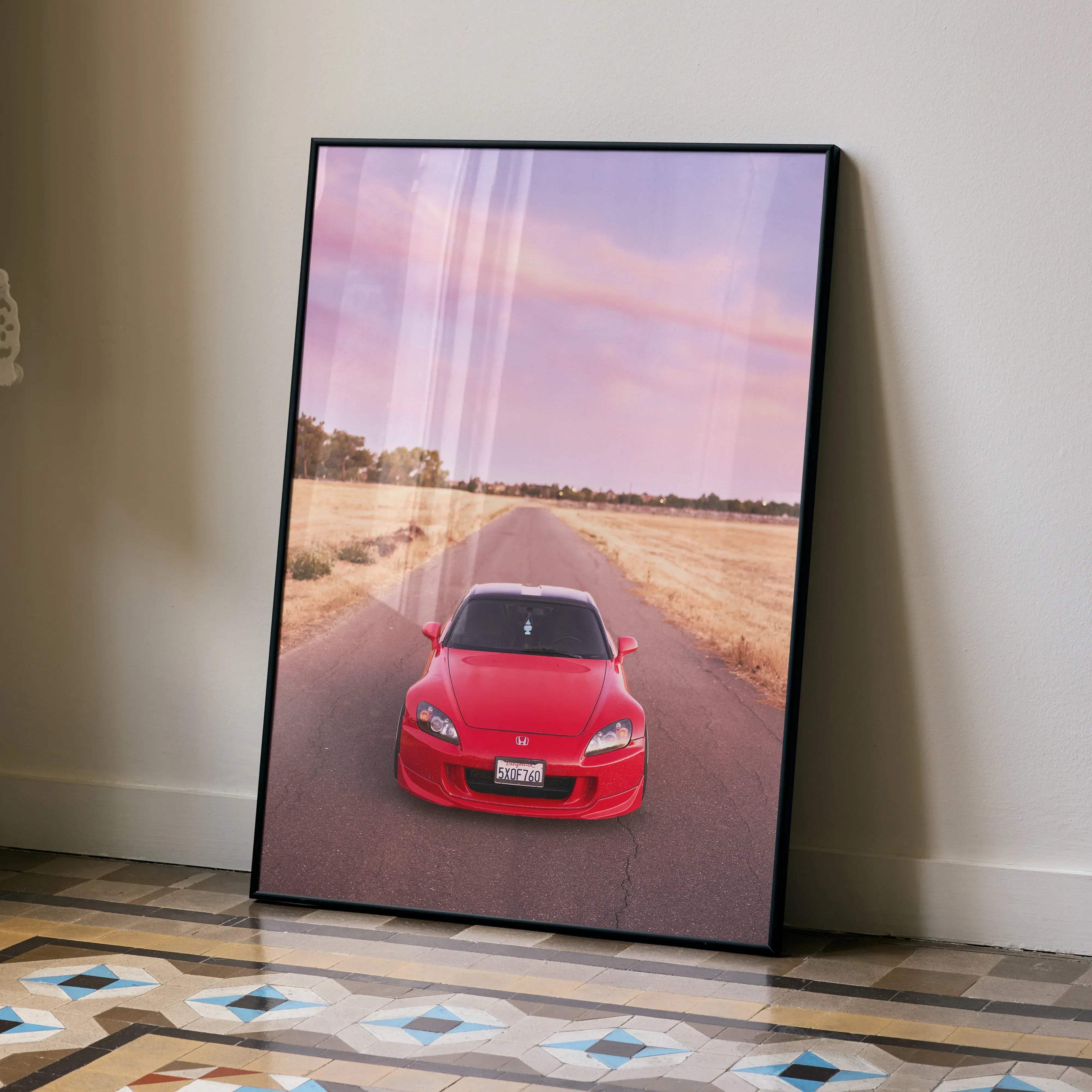Framed poster of a red honda s2000 sports car in high resolution leaning against a wall for car enthusiasts