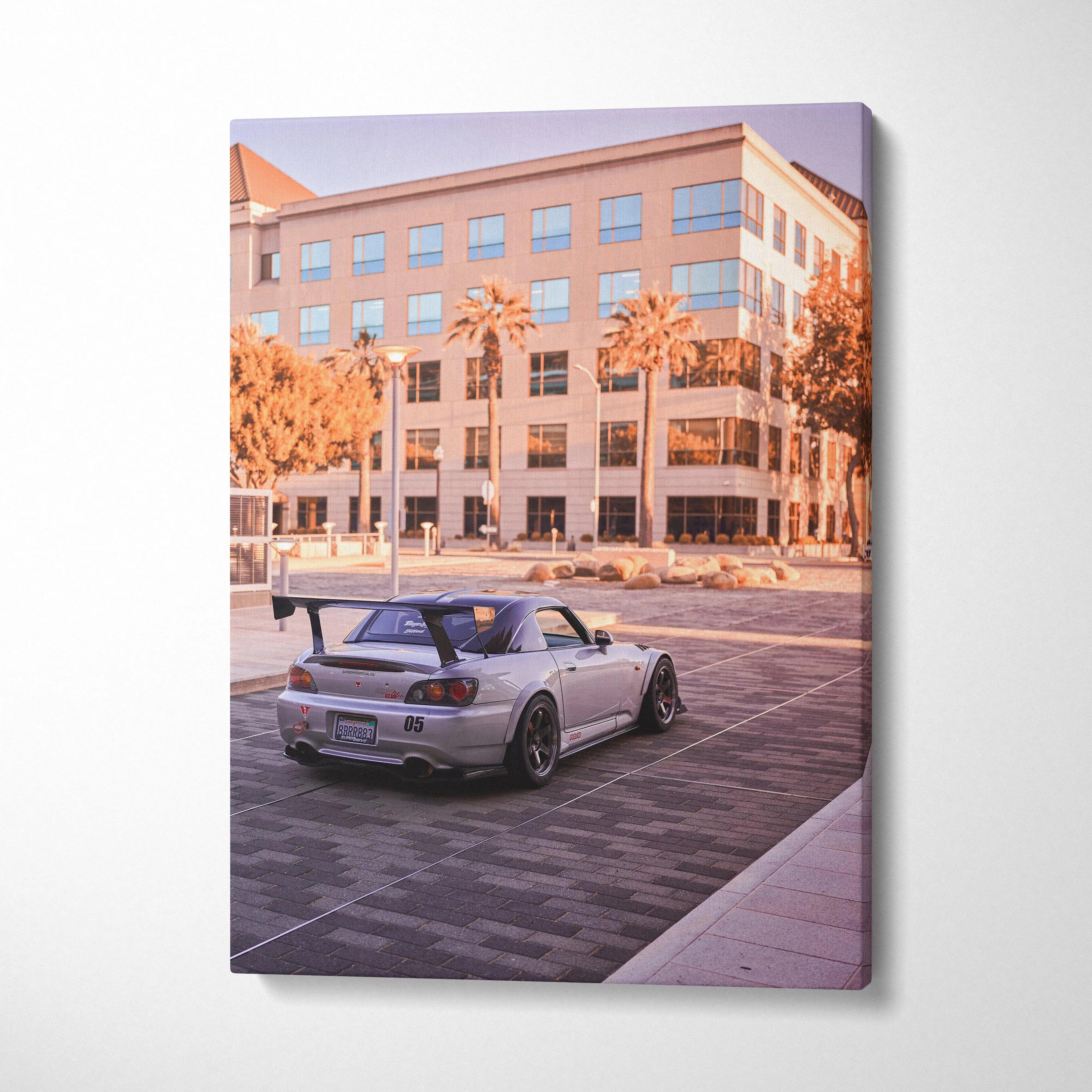 Honda S2000 canvas art showing silver sports car parked with building and palm trees, vertical wall art.