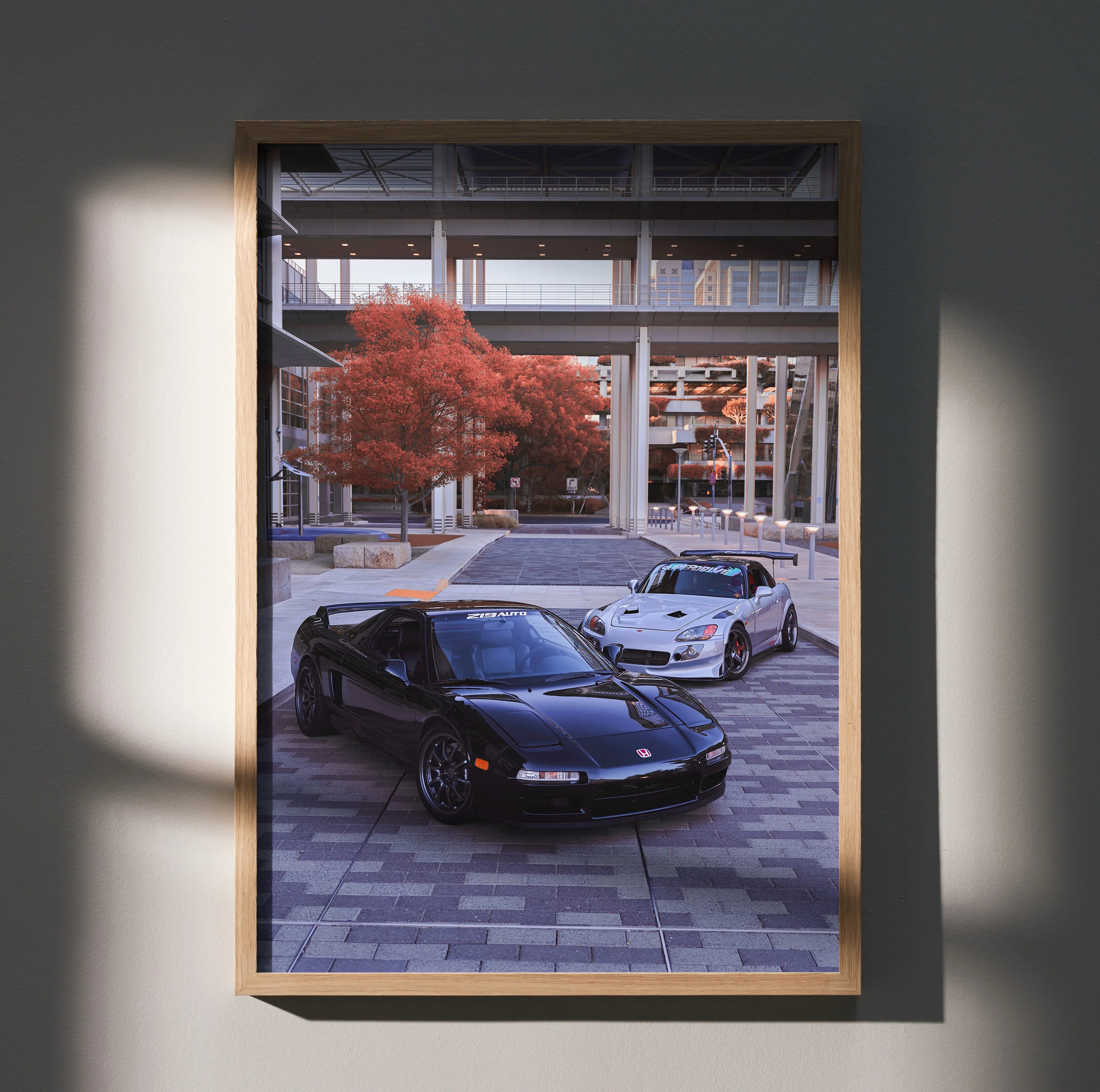 Acura NSX and Honda S2000 parked under modern cityscape autumn trees poster wall art.