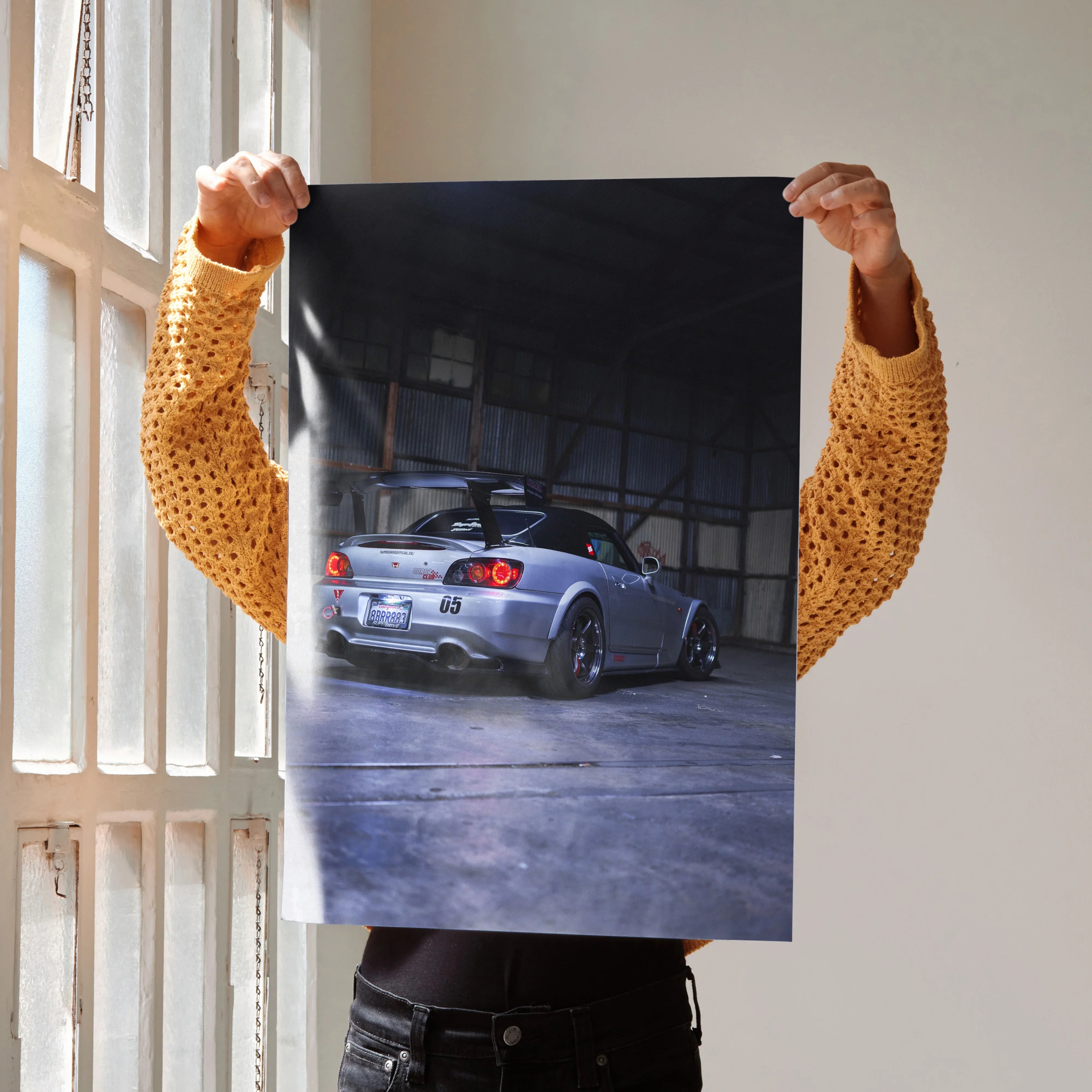 Honda S2000 poster featuring a silver sports car in a dimly lit garage, sleek wall art design.