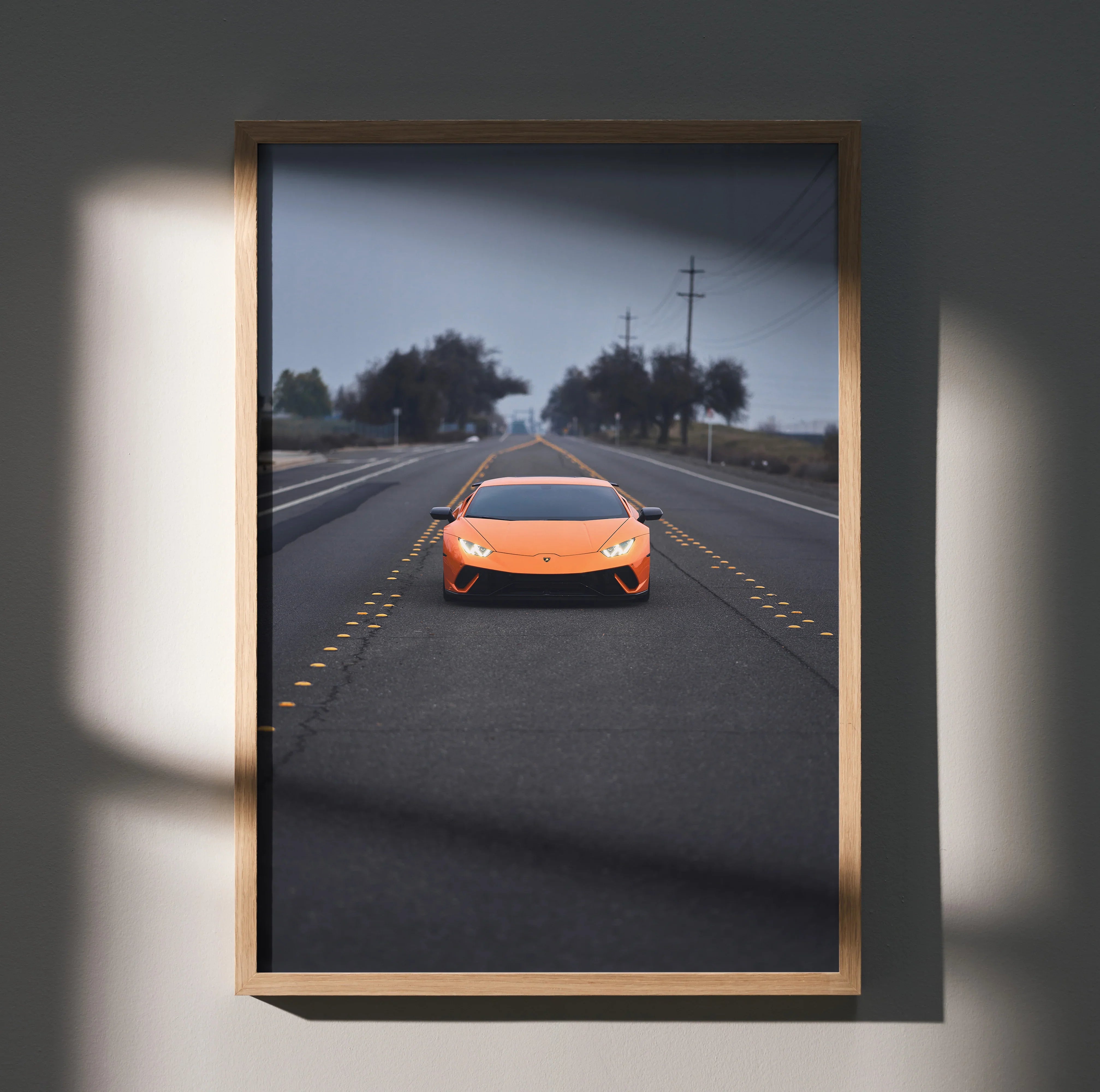 Lamborghini Huracan in orange on road poster, high resolution automotive wall art in wooden frame.