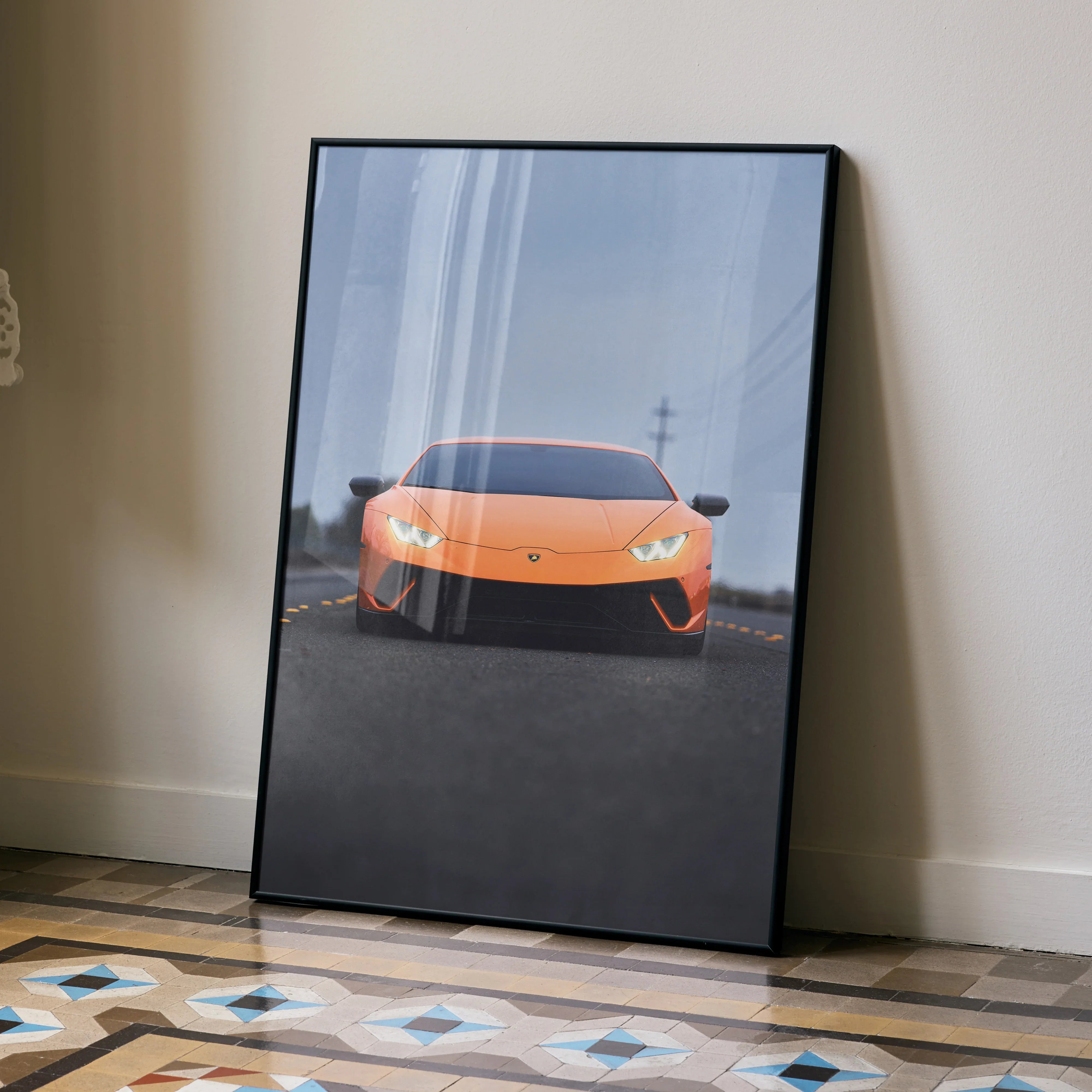 Lamborghini Huracan poster with vibrant orange sports car on road, modern wall art with black frame.