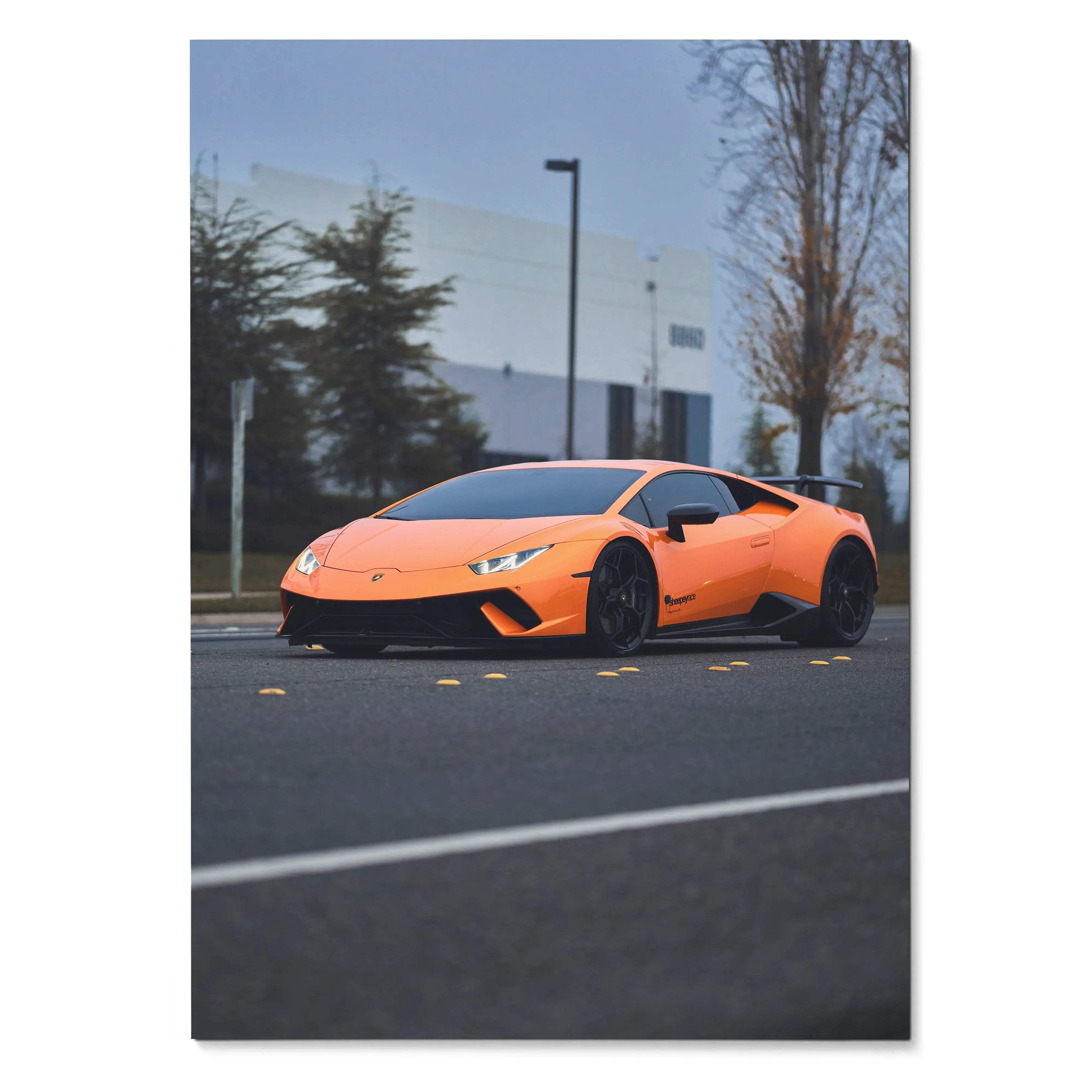 Orange Lamborghini Huracan parked on street with urban background poster wall art.