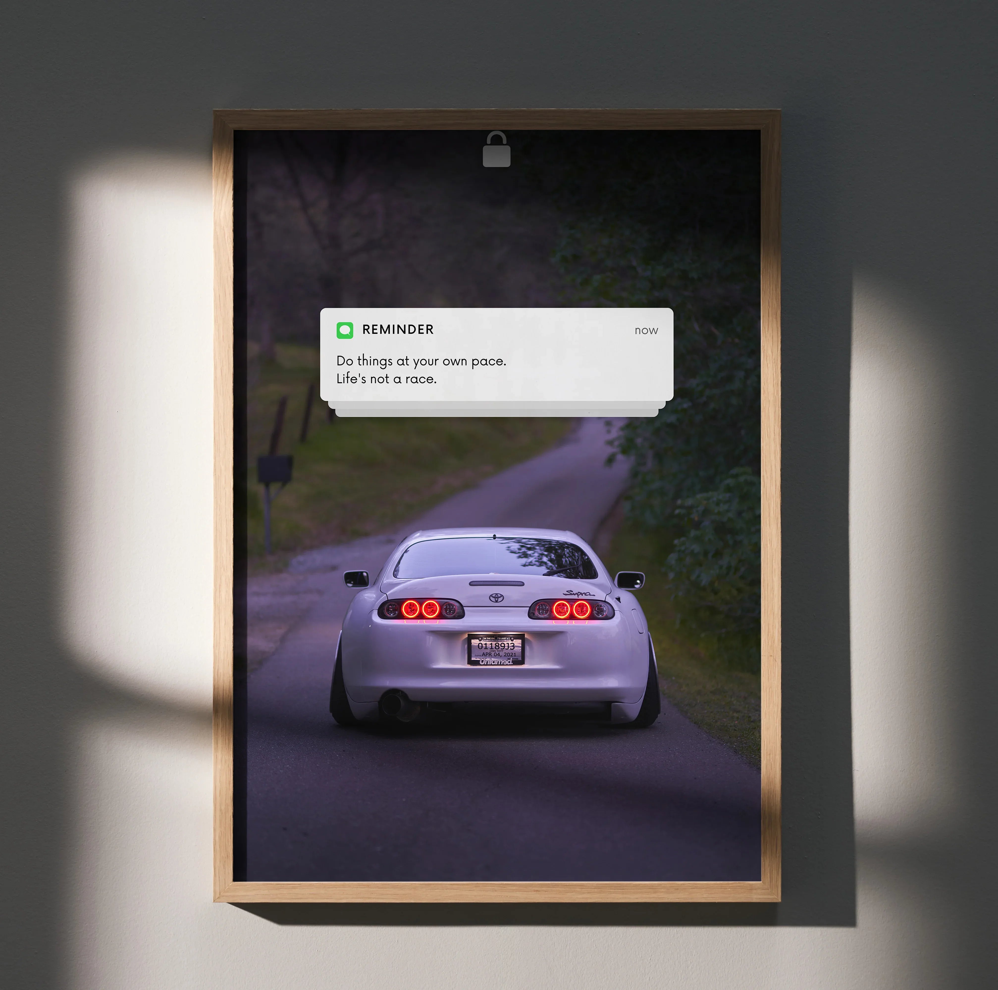Toyota Supra Mk4 poster wall art with rear view on winding road and motivational text notification.