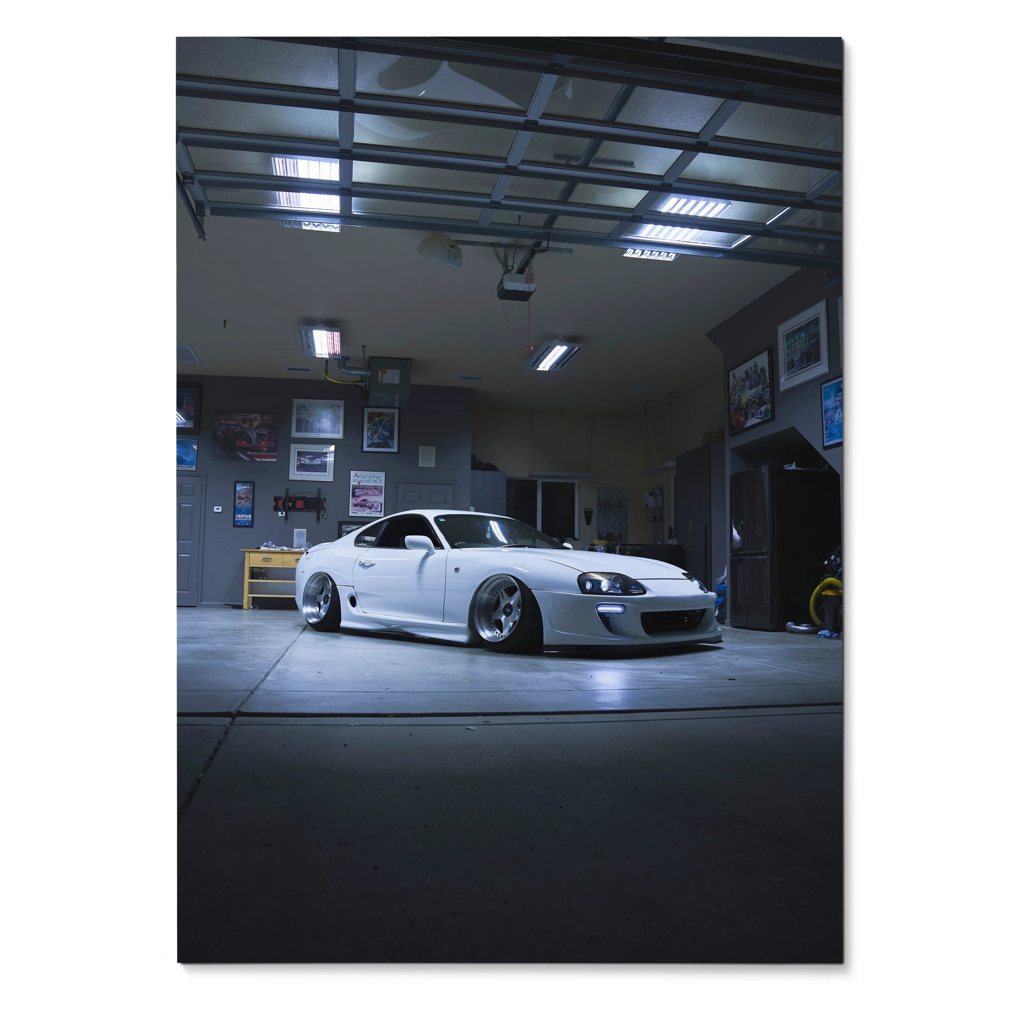 White Toyota Supra MK4 parked in dimly lit garage poster wall art with automotive decor.