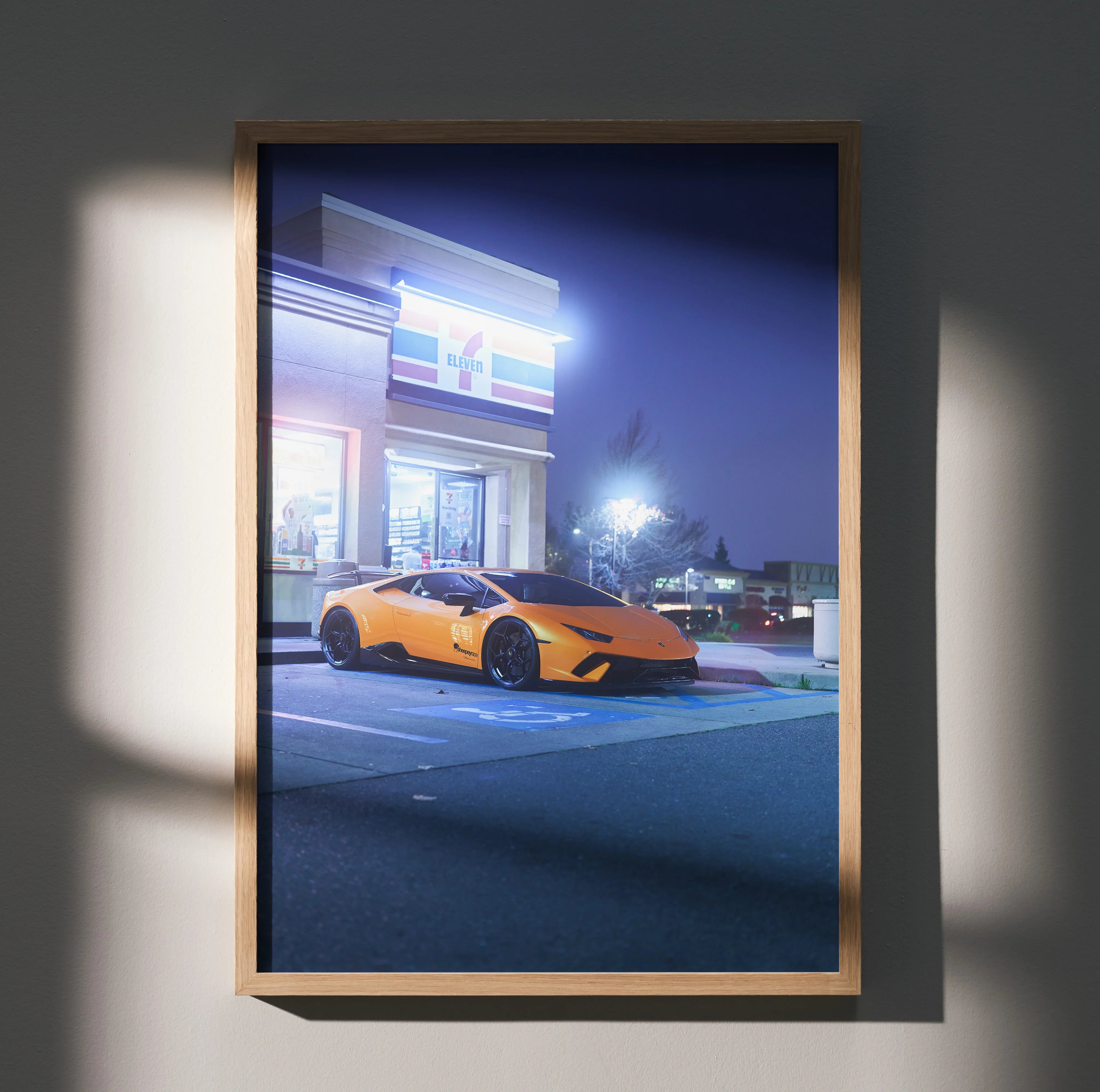 Lamborghini Huracan in vibrant orange parked at night, high-resolution poster wall art with sleek modern framing.
