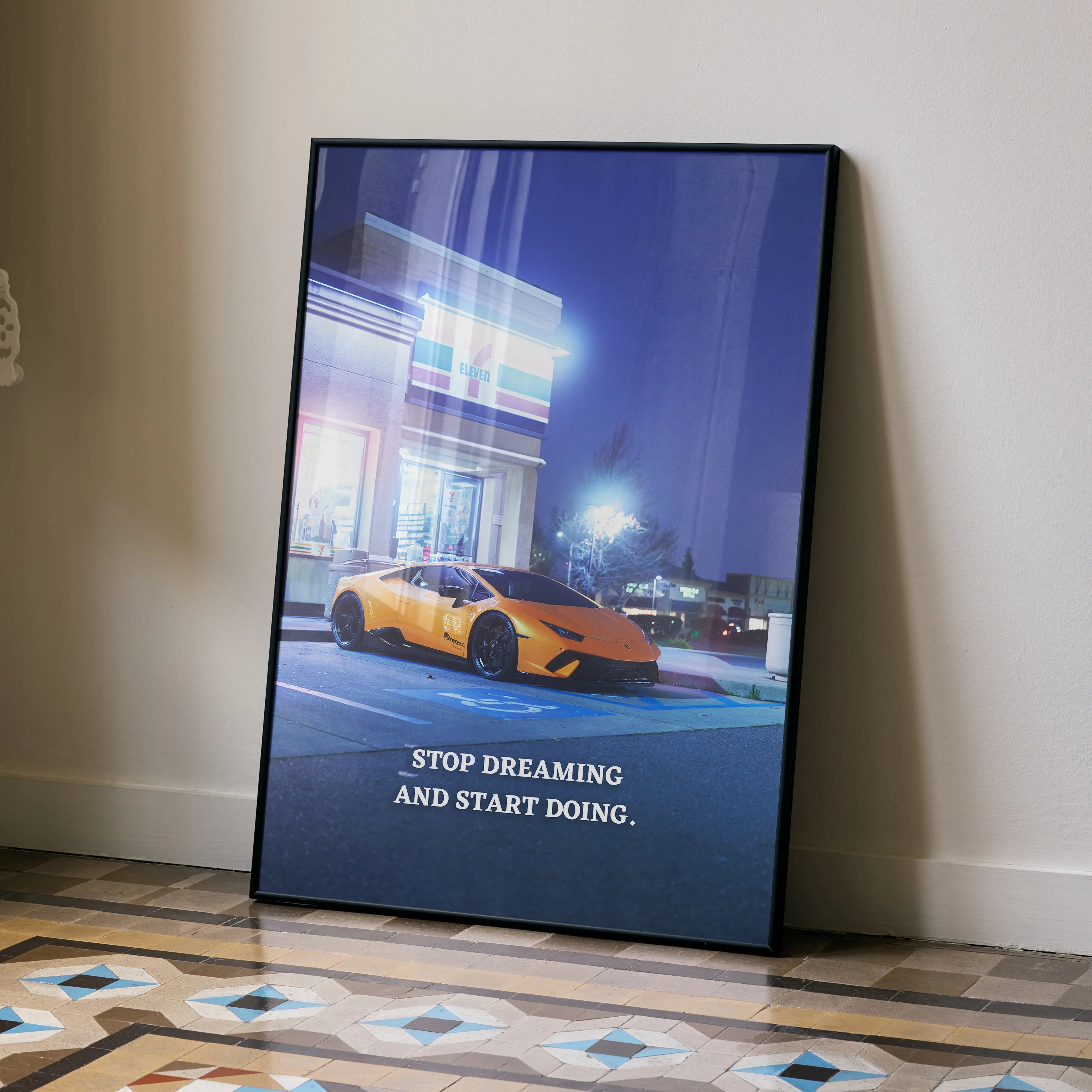 Motivational poster wall art featuring a yellow Lamborghini Huracan parked at night with the text "Stop Dreaming and Start.
