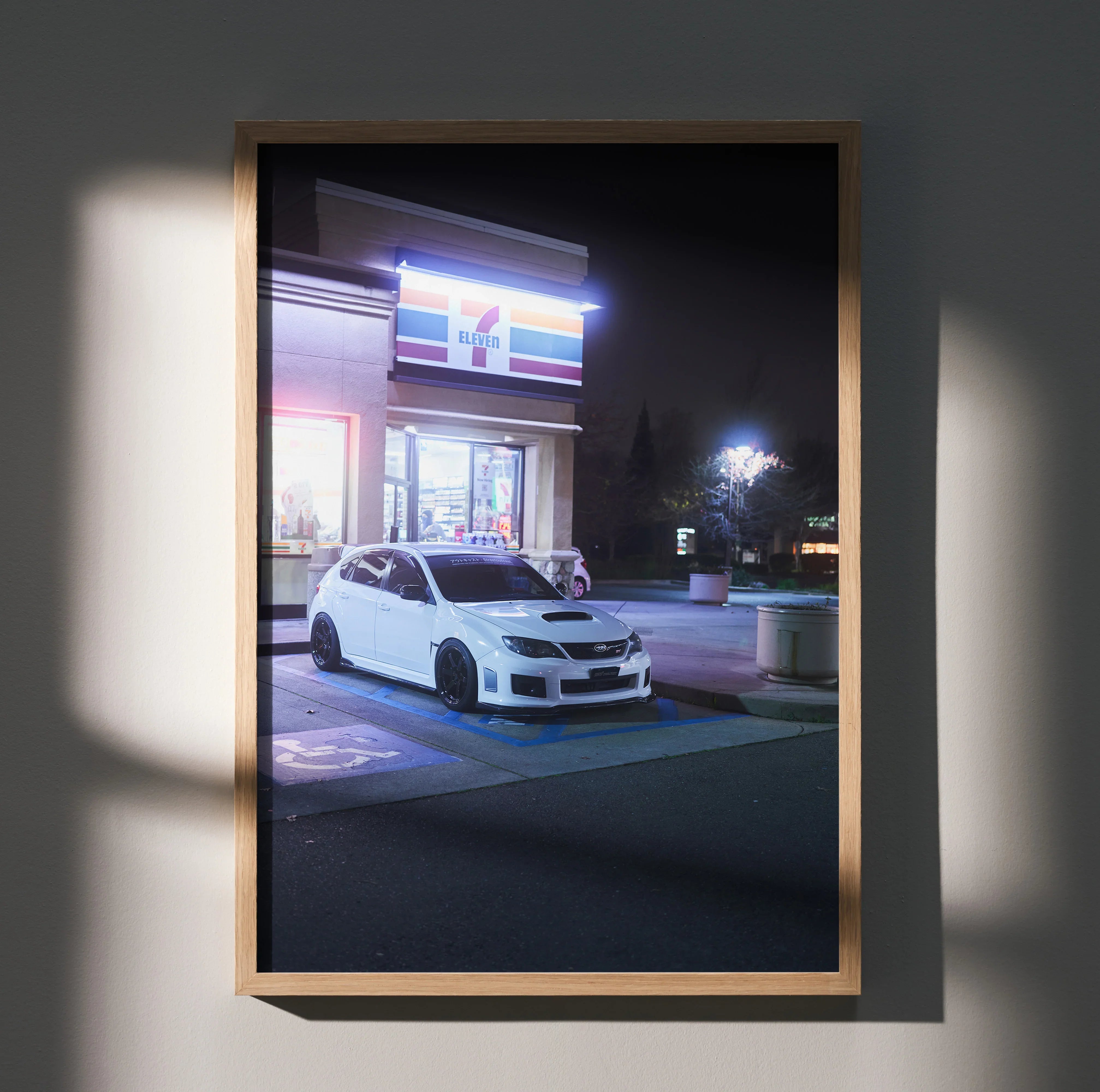 Subaru WRX STI parked at night under neon lights poster wall art in wooden frame.
