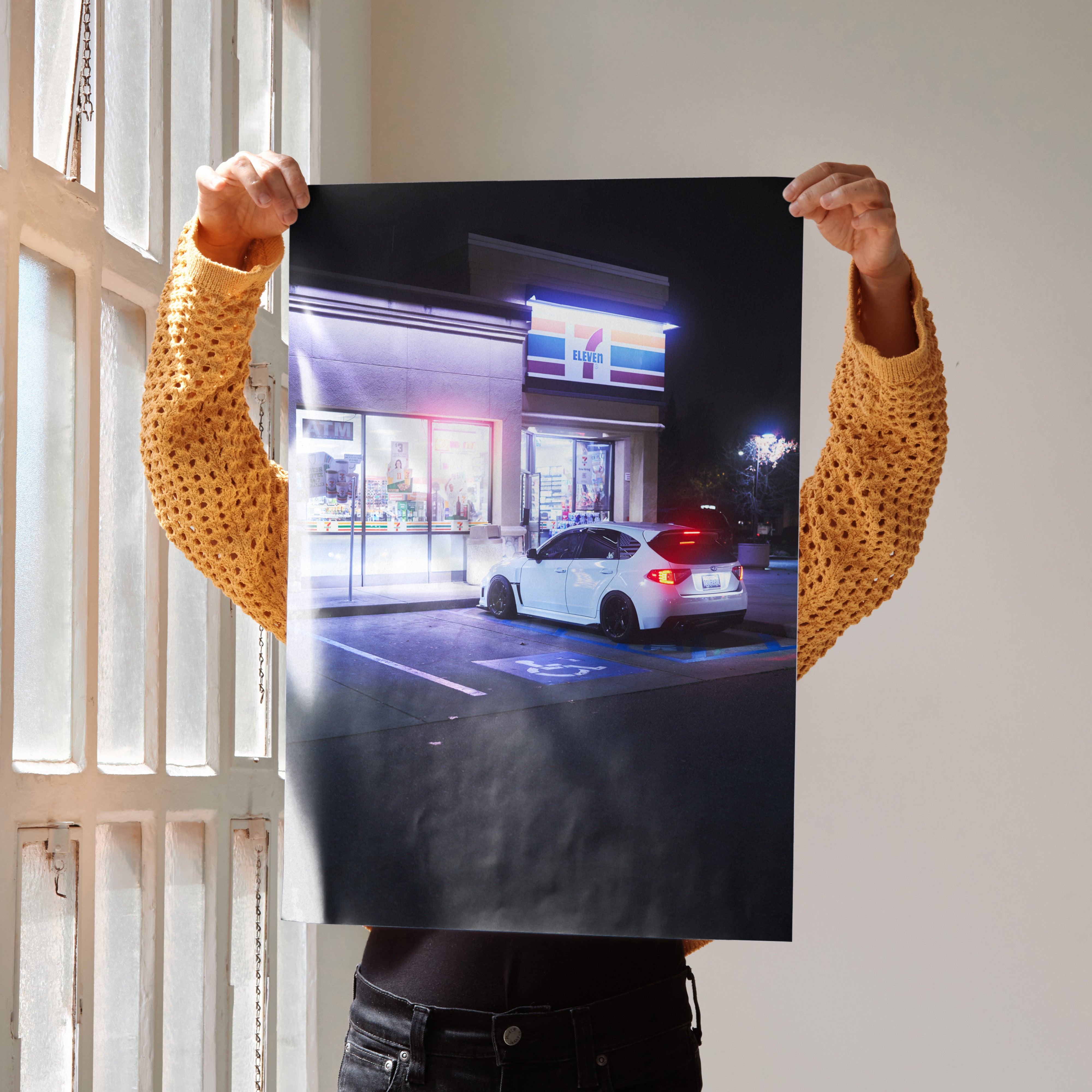 Subaru WRX STI poster featuring a night scene with a white car and illuminated building wall art.