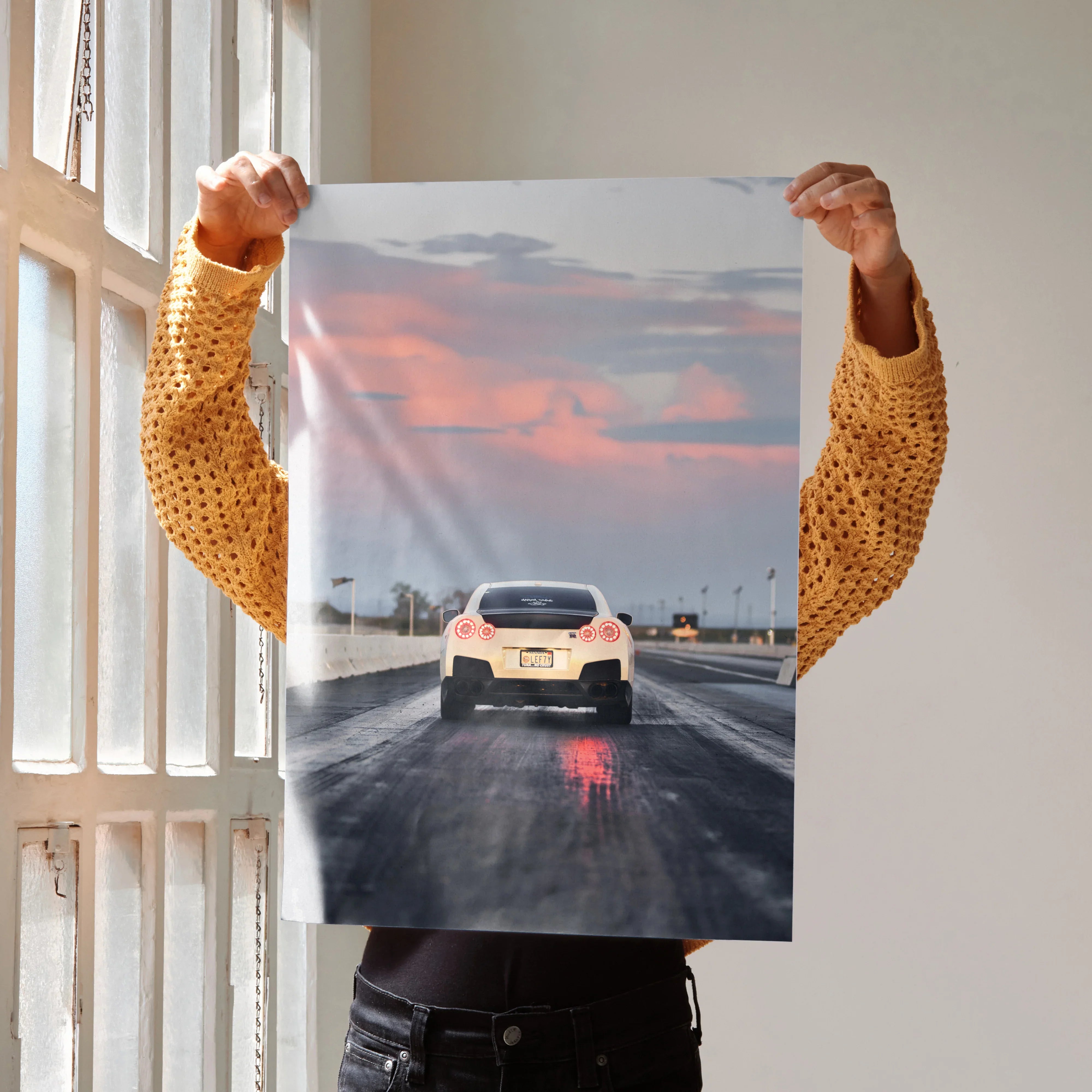 Nissan GTR R35 racing poster wall art with sunset sky and wet track reflections.