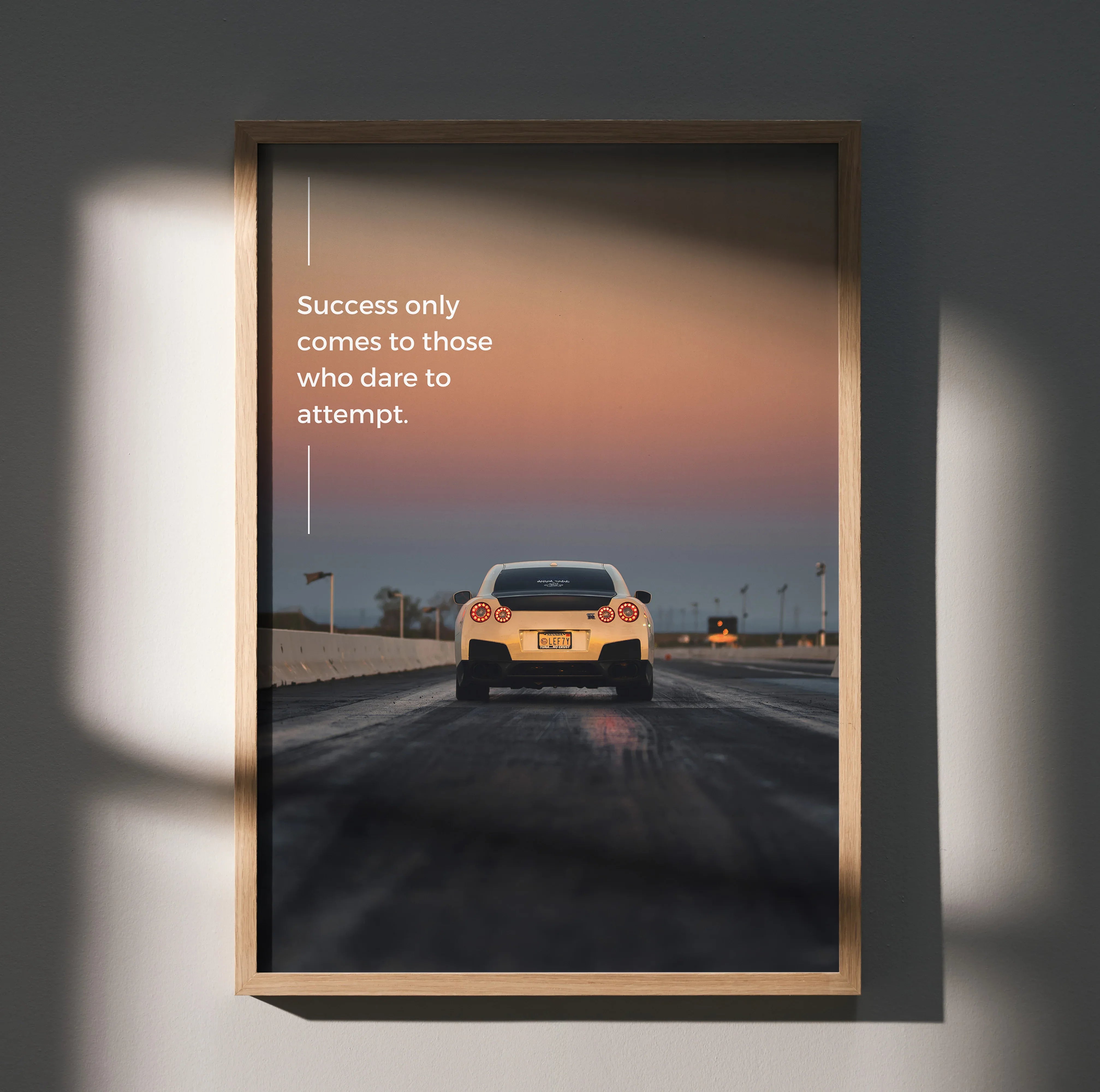 Motivational poster wall art featuring rear view of Nissan R35 GT-R on road at sunset with inspiring quote.