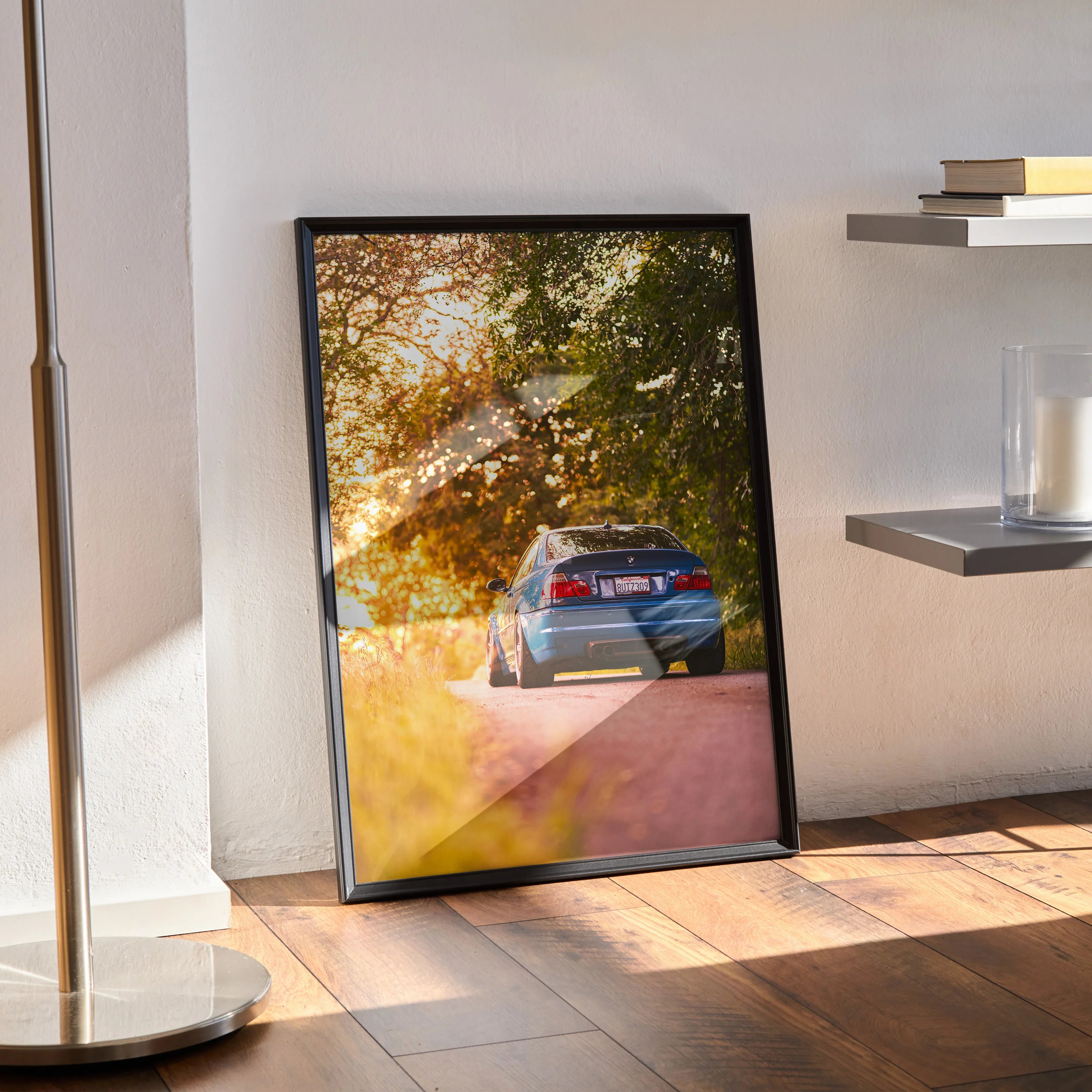 BMW E46 M3 driving through sunlit autumn trees poster wall art with warm golden tones.