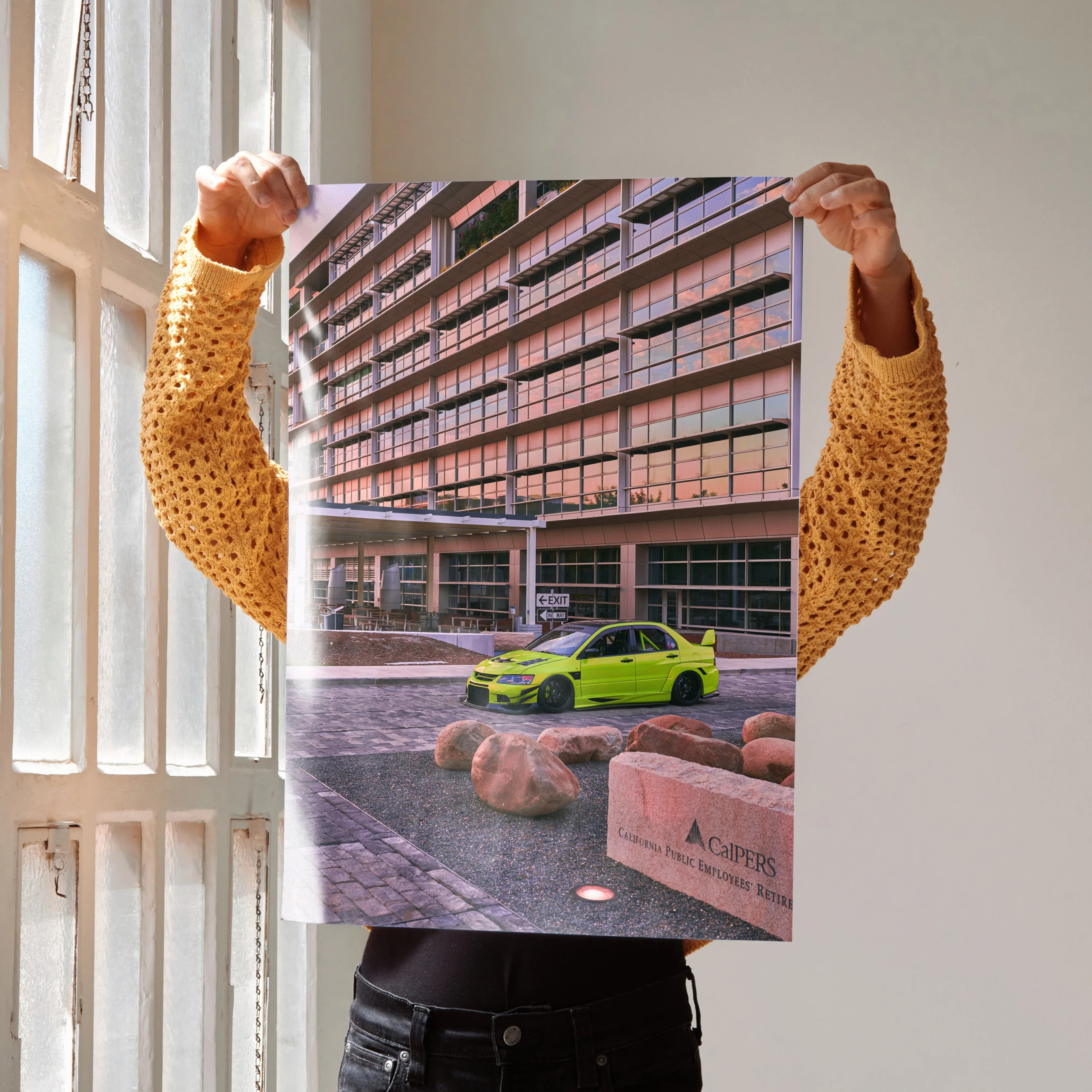 Poster featuring vibrant Mitsubishi Evo 9 car in front of modern building, high-resolution wall art.