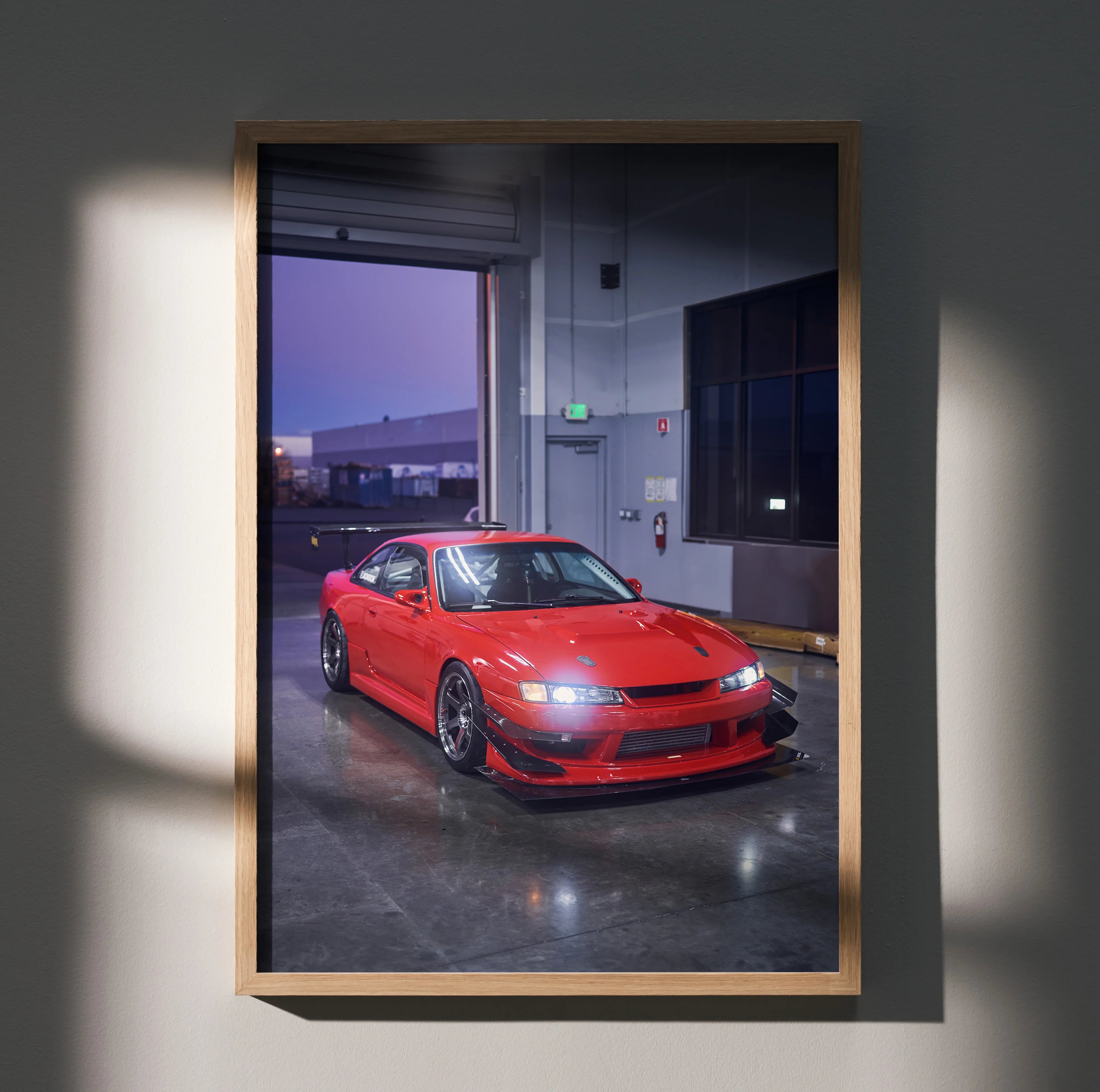Red Nissan 240sx S14 Kouki parked indoors poster wall art in wooden frame.