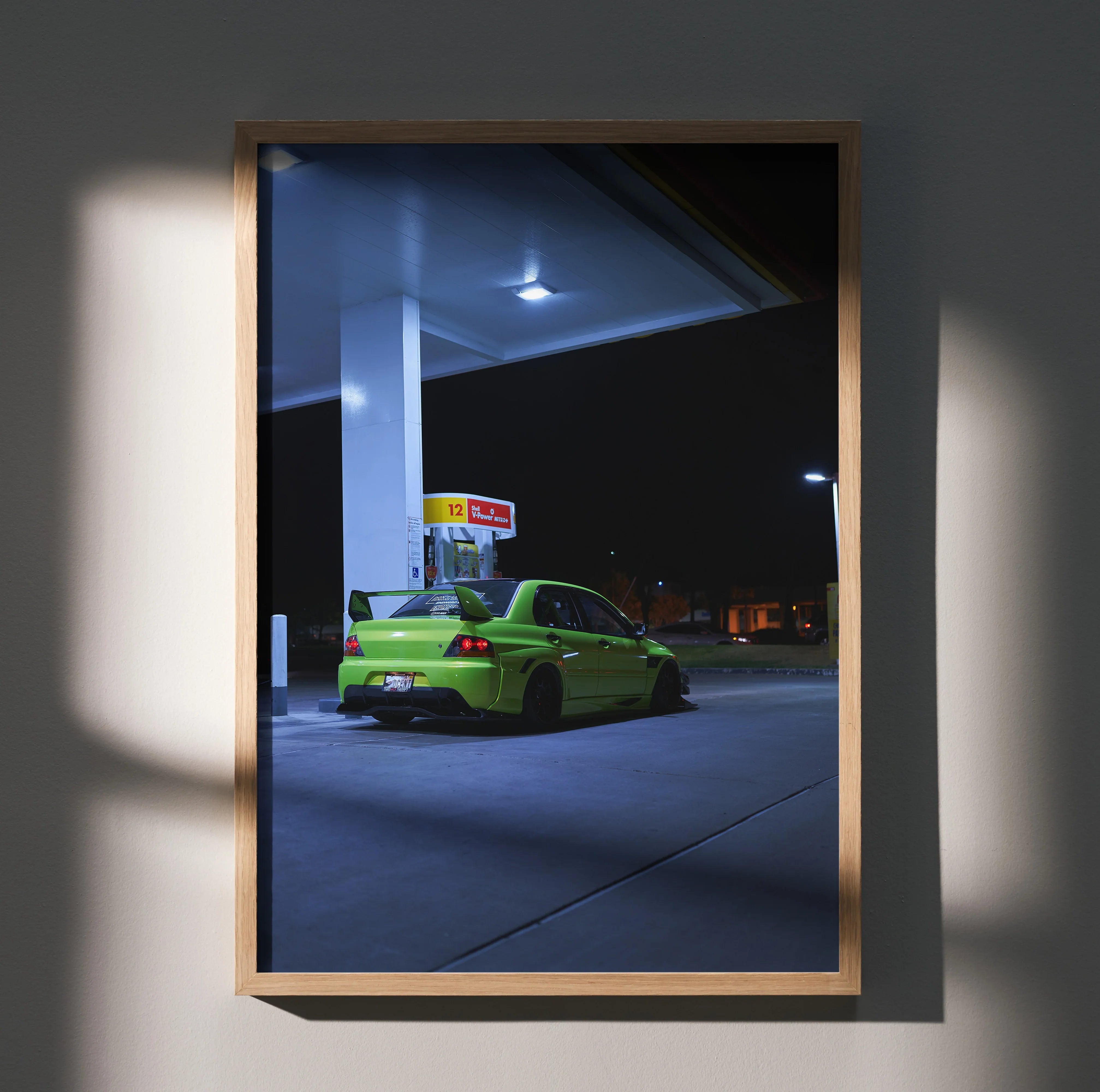 Mitsubishi Evo 9 in bright green parked at gas station at night poster wall art.