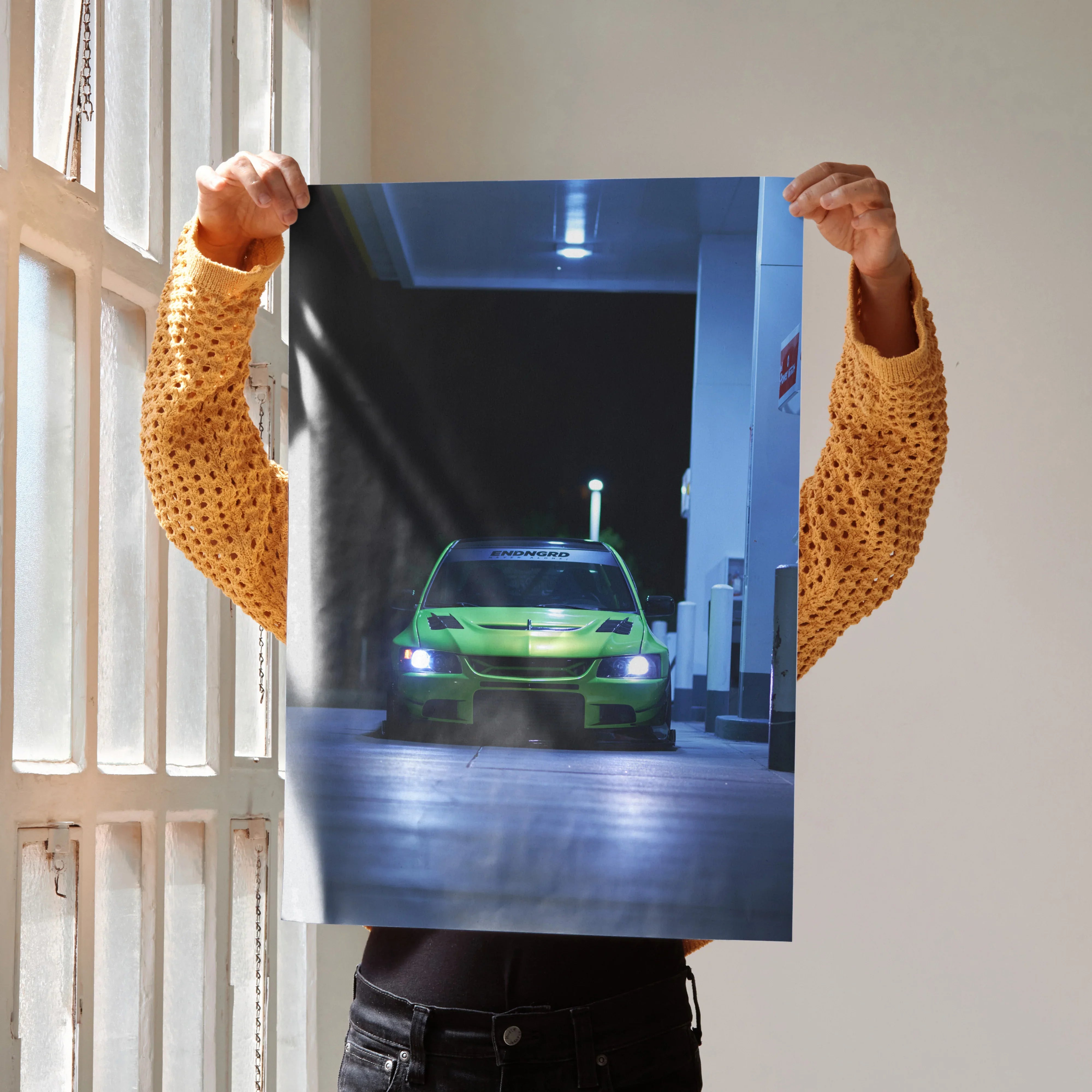 Mitsubishi Evo 9 poster with glowing headlights in a dark urban setting, wall art for car enthusiasts.