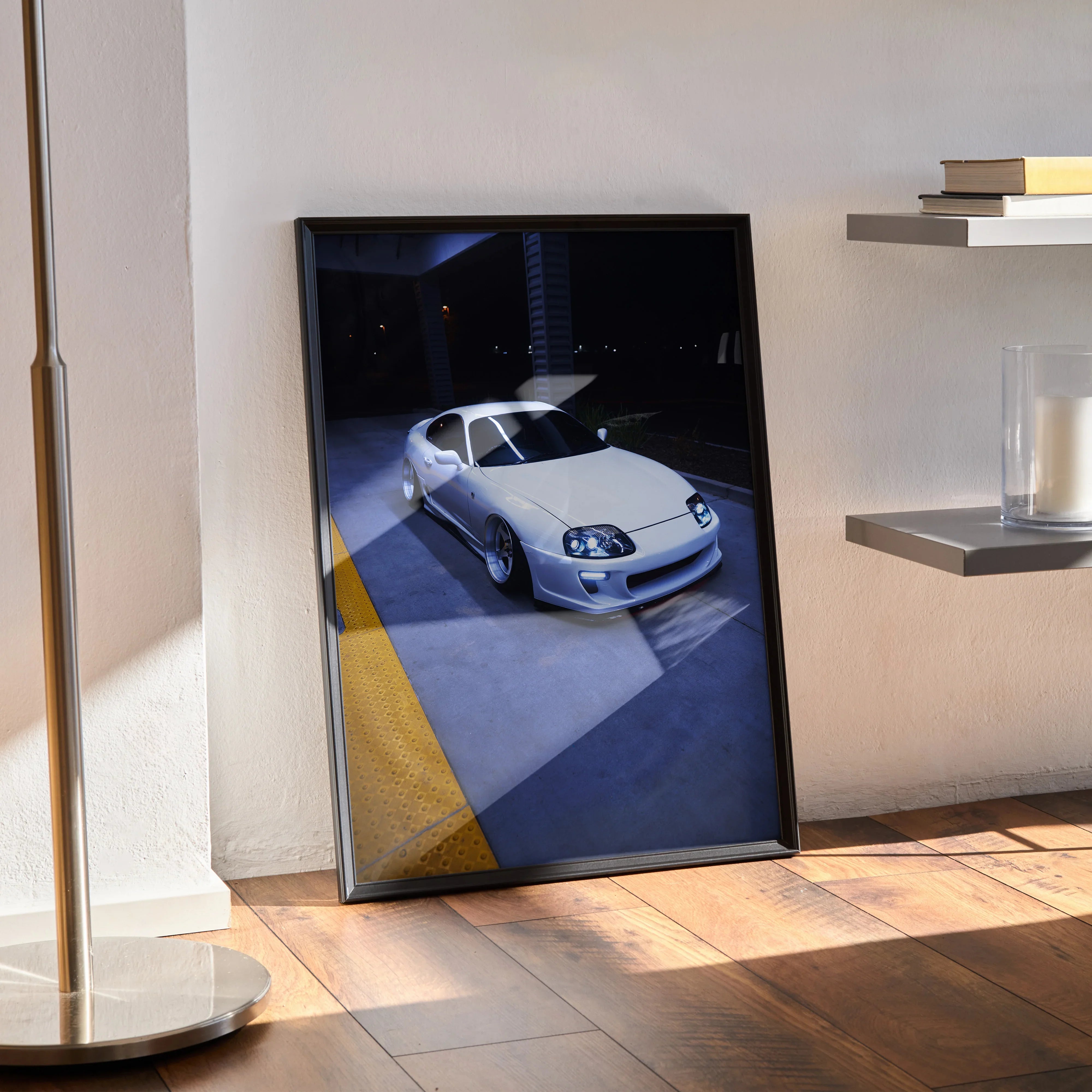 Toyota Supra MK4 poster wall art featuring a white Supra in a garage with dramatic lighting.