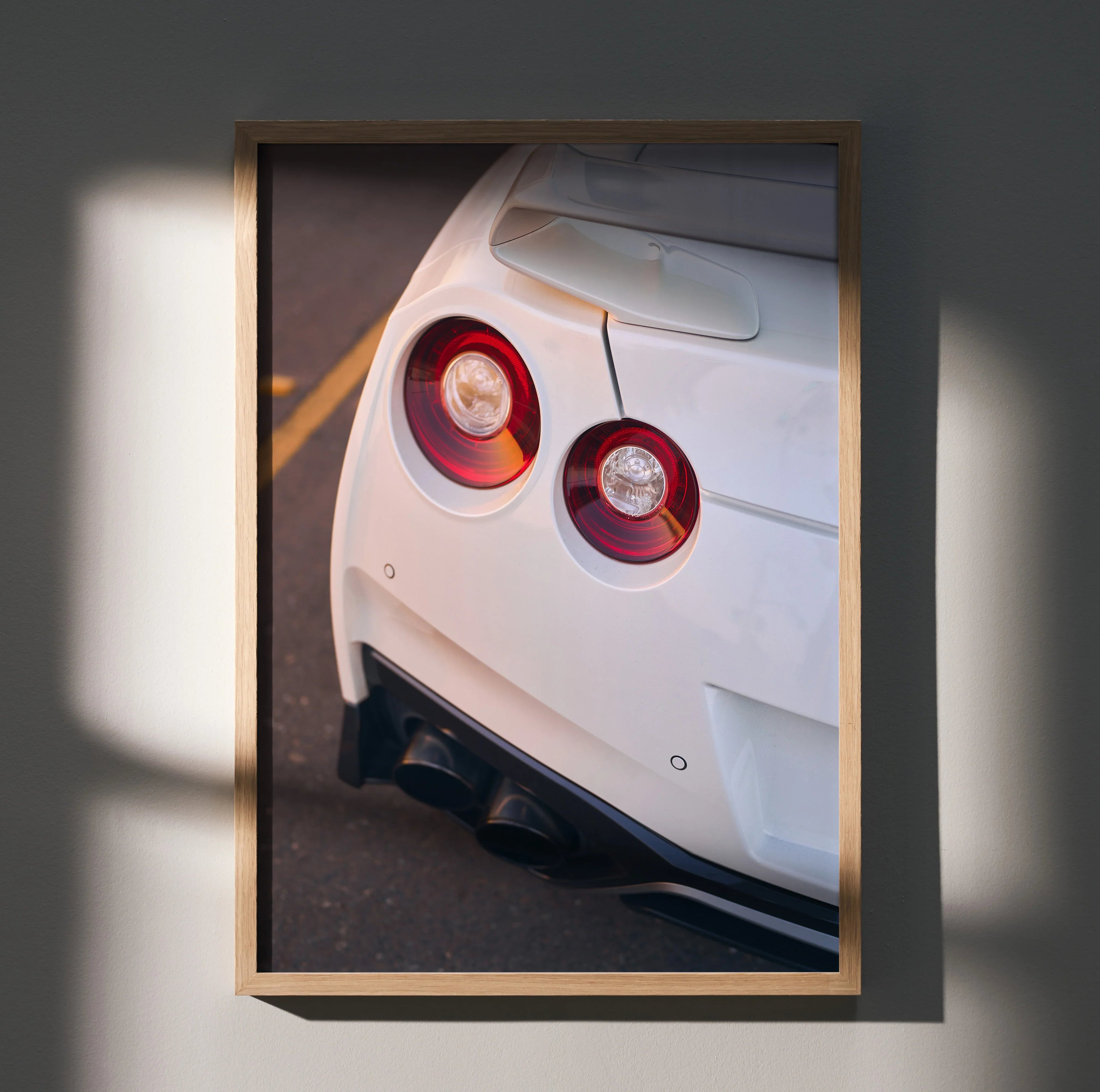 Nissan GTR R35 white rear view poster with iconic round tail lights, automotive wall art.