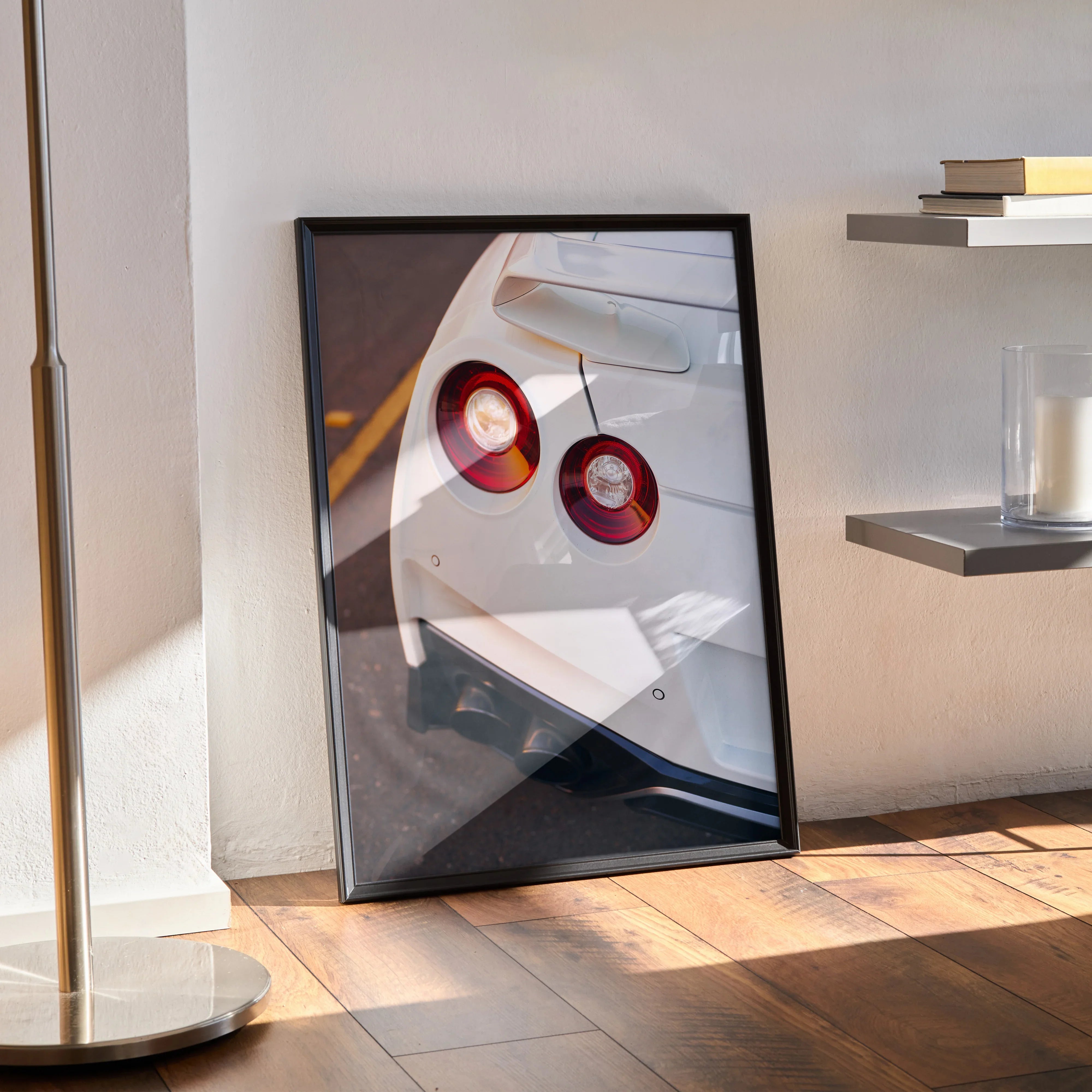 Nissan GTR R35 rear light close-up poster wall art in black frame leaning on floor.