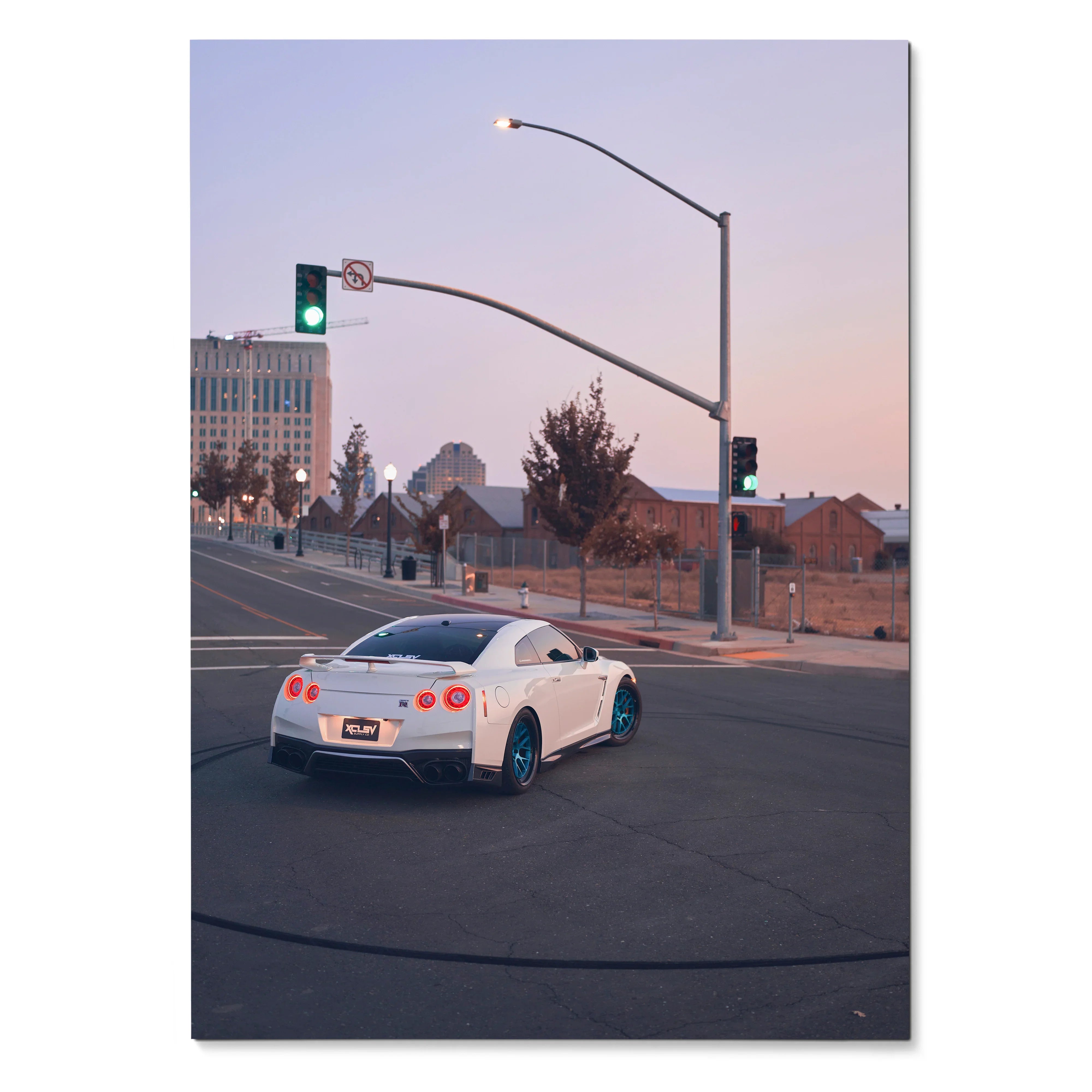 Nissan GTR R35 in white at urban intersection against dusk sky poster wall art.