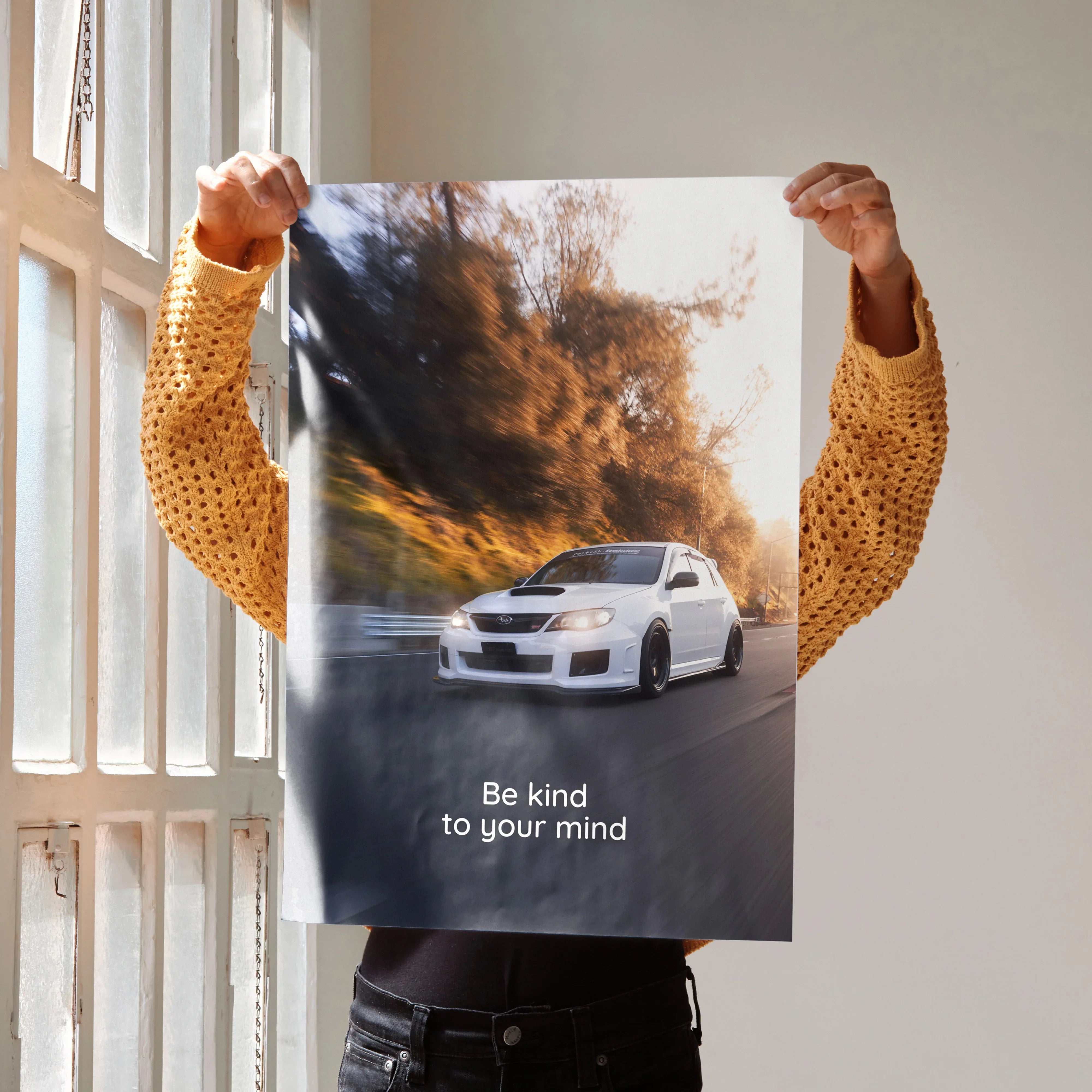Motivational poster wall art featuring white Subaru WRX STI on winding road with inspiring text Be kind to your mind.