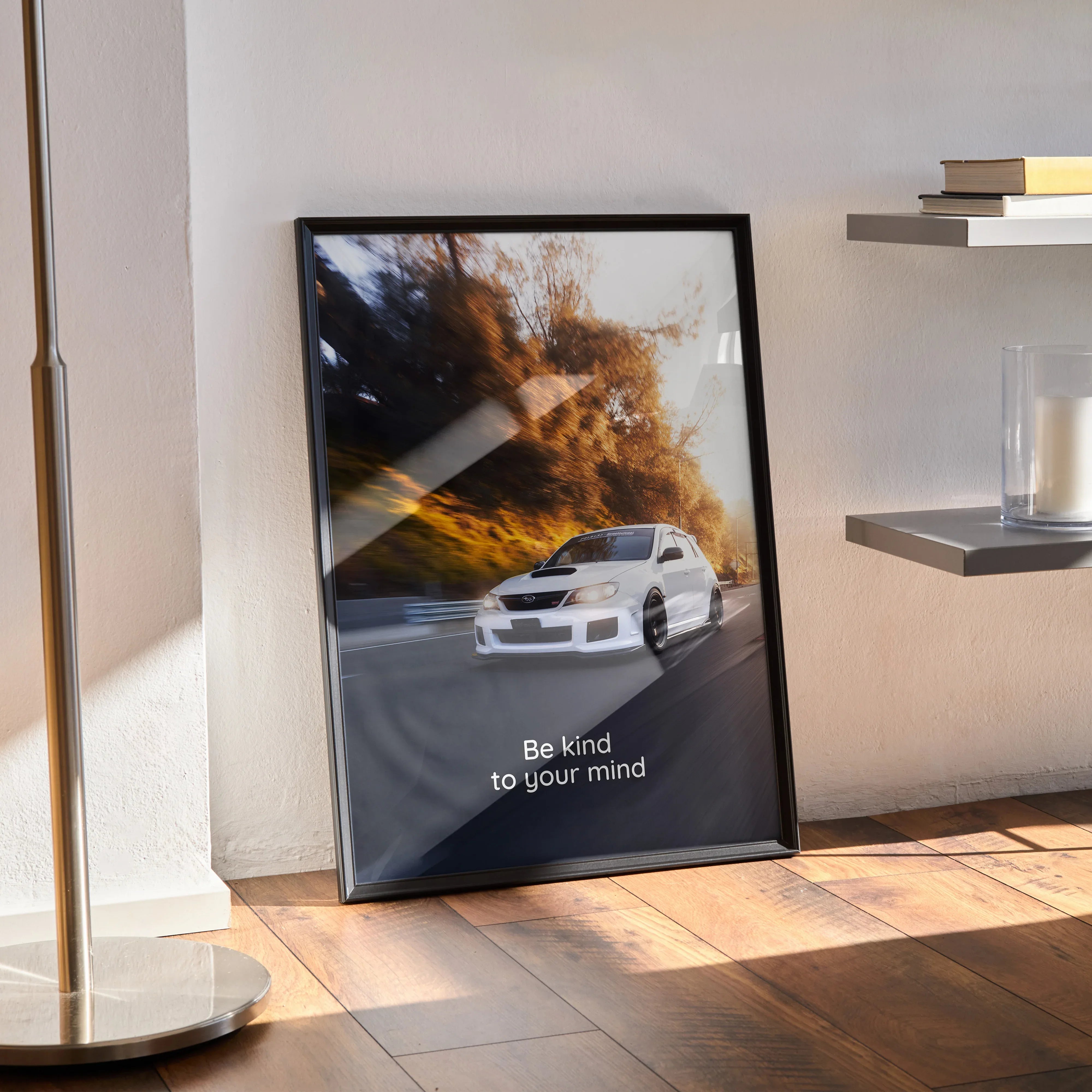 Motivational poster with white Subaru WRX STI driving through dirt and inspiring text "Be kind to your mind" in black frame.