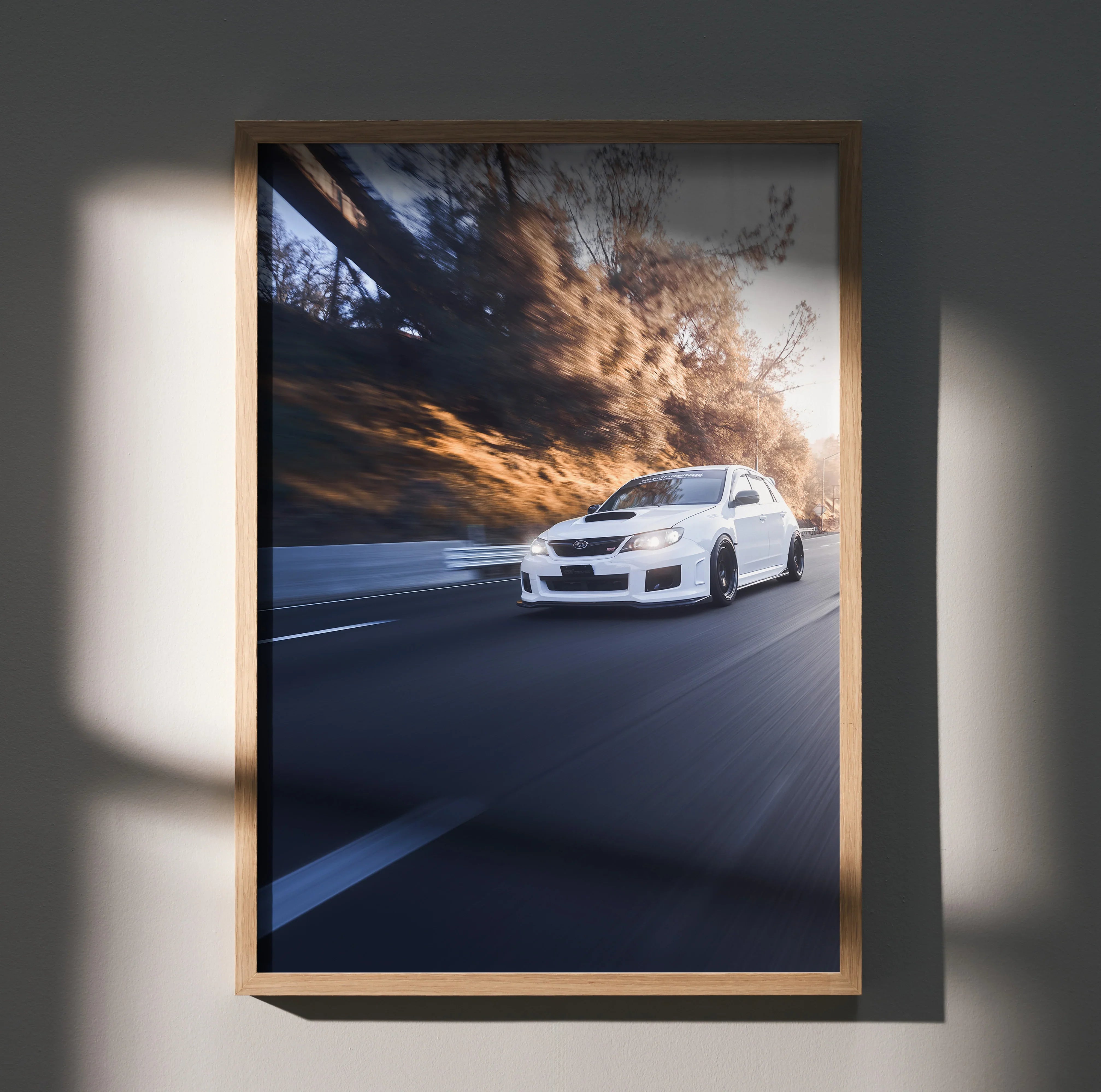 Subaru WRX STI white car racing on road at sunset poster wall art in wooden frame.