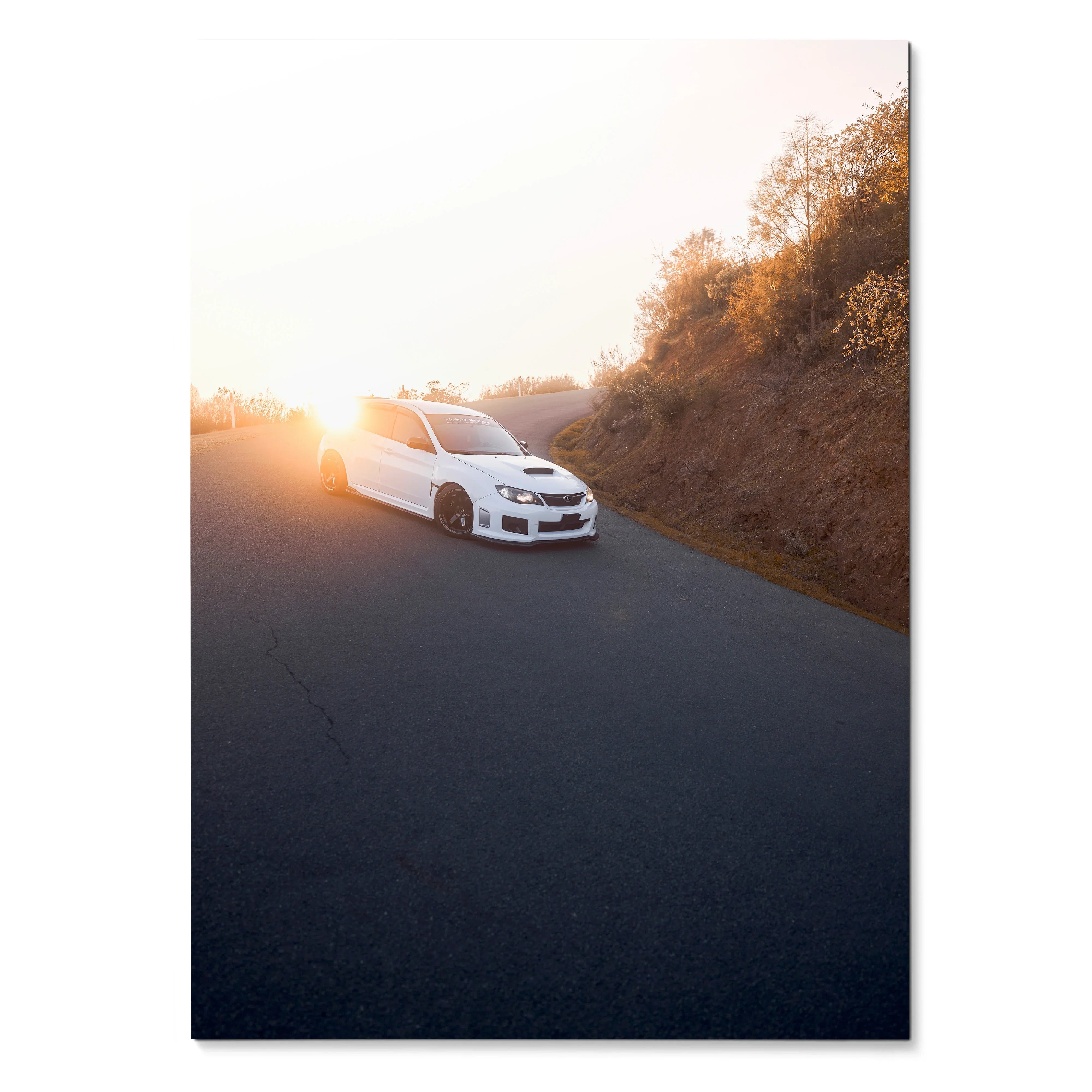 White Subaru WRX STI driving on winding road at sunset poster wall art.