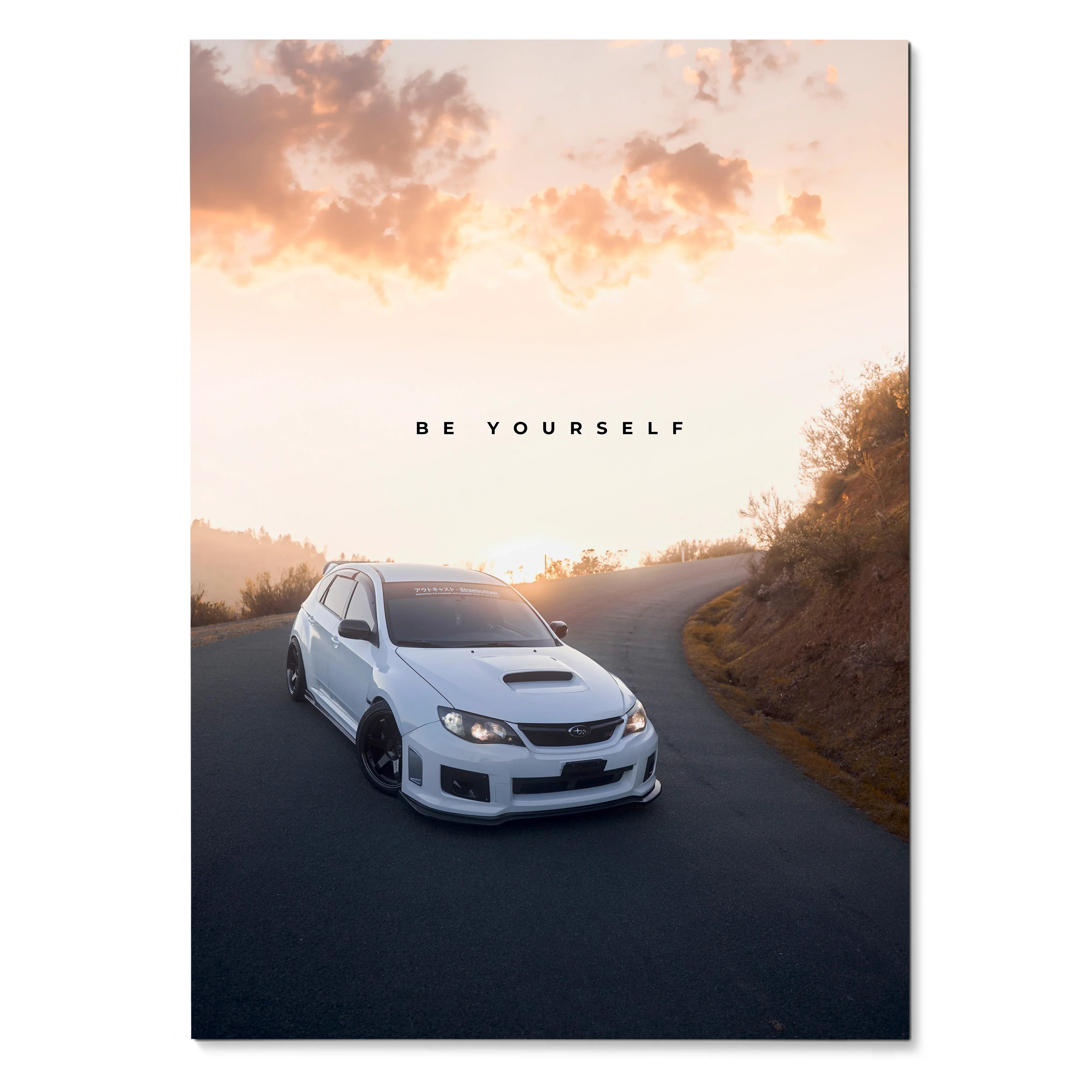 White Subaru WRX STI on winding road at sunset with "Be Yourself" text motivational poster wall art.