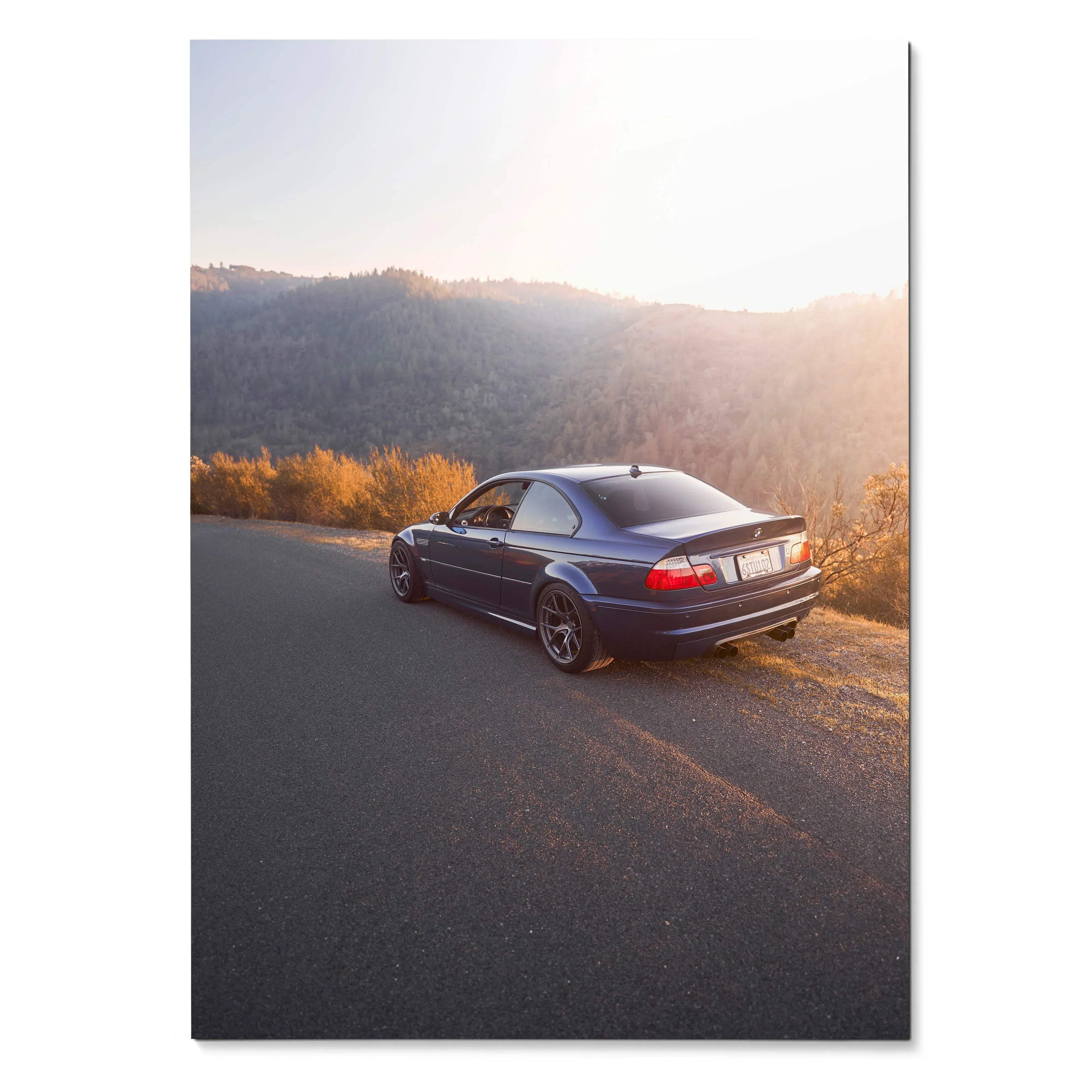 BMW E46 M3 poster showing rear three-quarter view on sunset road, wall art for car enthusiasts.