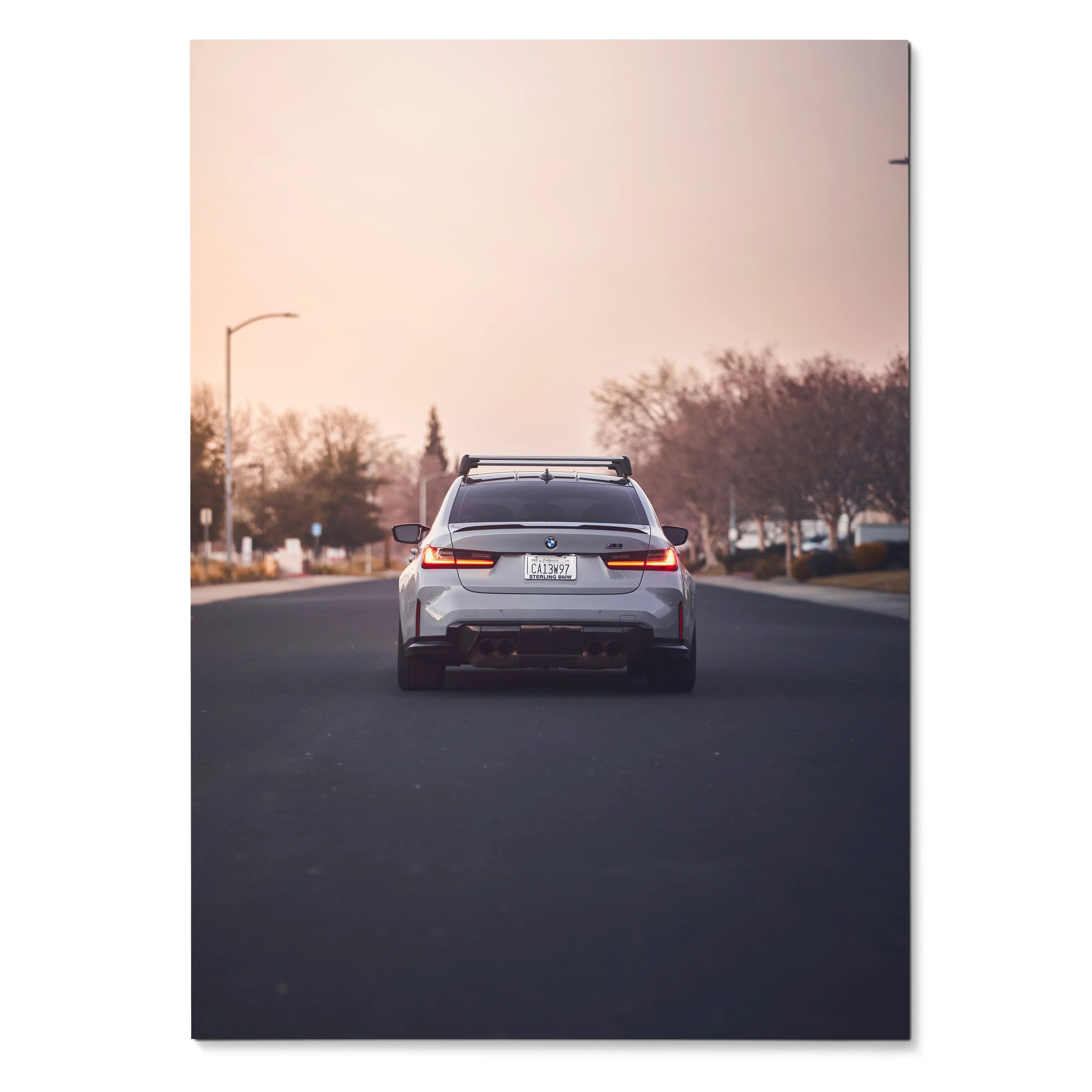 BMW G80 M3 rear view poster wall art with sunset and urban background.