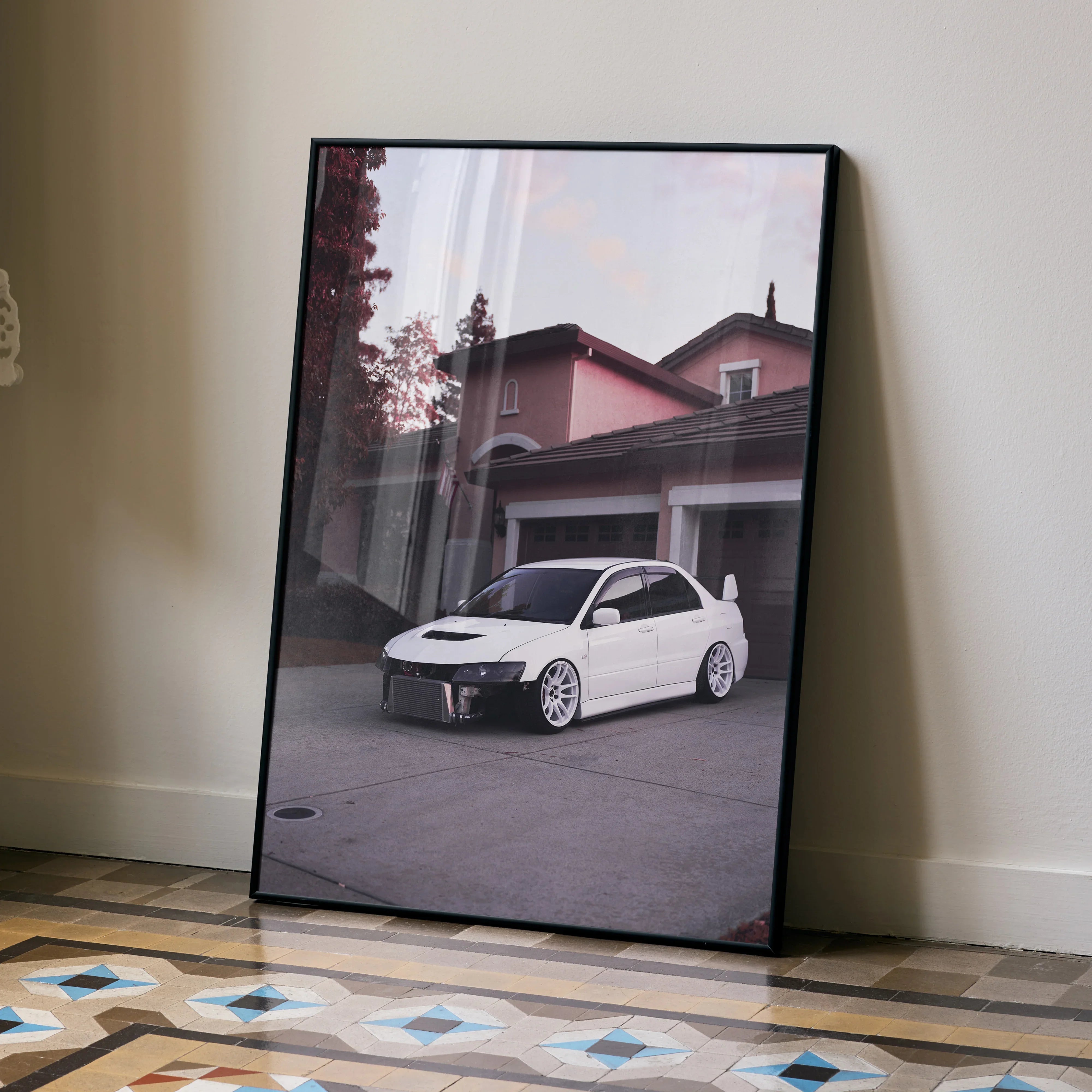 Mitsubishi Evo 8 art poster with white car parked in front of house, modern wall art in black frame.